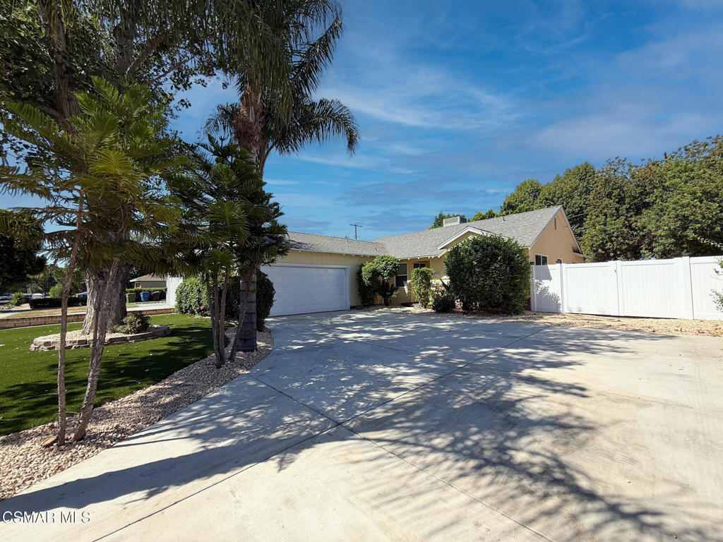 Step into this beautifully remodeled single-story home featuring 3 spacious bedrooms and versatile living spaces designed for today's lifestyle. Two large flex areas provide endless possibilities--whether you're envisioning a family room, entertainment lounge, den, or even a potential 4th bedroom. The dining area flows seamlessly from the kitchen into the living spaces, making everyday living and entertaining a breeze. The kitchen boasts granite counters, bright natural light, and brand-new appliances, while new laminate flooring throughout contrasts elegantly against crisp white walls and baseboards. One bedroom offers a convenient en-suite layout with dual entrances--ideal for a home office or guest retreat. Down the hall, you'll find another guest bedroom and the primary suite, each with ample closet space, complete with double-shelf organizers for maximum storage. A dedicated laundry room is thoughtfully positioned just off the kitchen and garage, complete with a new stacked washer/dryer unit. Outdoors, the property truly shines. The backyard is a massive, private retreat perfect for entertaining, kids at play, or simply relaxing under the California sun. Freshly installed artificial turf in both front and back yards ensures year-round beauty with minimal maintenance. On the side, a wide, secured area with new vinyl fencing and gates offers incredible flexibility for boat or RV parking, extra storage, or a hobby space. The sprawling front yard, oversized lawn, and expansive driveway provide even more functionality and curb appeal. Inside and out, this home is move-in ready and filled with thoughtful updates. A must-see opportunity you won't want to miss!
