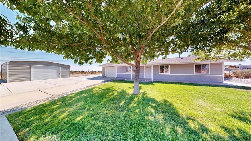 Welcome to 11825 Riggins Road — a freshly updated 3-bedroom, 2-bath home on 2.29 acres, blending modern style with rural charm. Recently painted in a crisp 2025 gray-and-white palette, this home features a spacious living room with a cozy wood stove tucked in the corner, a galley kitchen with ample cabinetry, and a dining area with sliding glass doors opening to the outdoors. Down the hall, you’ll find a well-appointed hallway bathroom, two front-facing bedrooms, and a private master suite at the back of the home with its own bathroom. Outside, enjoy a newly installed detached metal garage, expansive concrete areas for easy parking, and a lush front lawn framed by mature trees in both the front and back yards. With open desert views and thoughtful upgrades and fenced, this property is ready for comfortable country living.