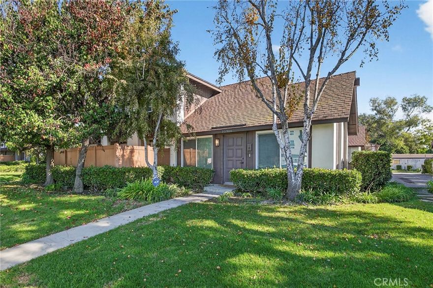 Discover contemporary living in this beautifully remodeled 3-bedroom, 2-bathroom condo, designed with a bright, open-concept flow that maximizes both space and natural light. The spacious main floor boasts high ceilings and features a seamless, stylish transition between the primary living/dining areas and the kitchen, unified by attractive wide-plank grey wood-look flooring. The kitchen effortlessly blends style and function, equipped with high-end features including crisp white cabinetry, sleek black fixtures, and KitchenAid stainless steel appliances. Features a spectacular custom-built-in white window bench adjacent to the kitchen, creating a cozy and flexible dining or reading area. The master is equally impressive with a generous walk-in closet and a luxurious bathroom featuring a dual-sink vanity. For added convenience, the home includes a separate laundry room and an attached two-car garage with direct access. Outside, the private, fenced patio is ideal for relaxation with its durable concrete slab floor and natural shade from mature trees overhead. Best of all, this home is conveniently located close to the freeway, placing you just minutes from local markets and favorite restaurants, offering the perfect blend of sophisticated interiors, comfort, and unparalleled practicality.