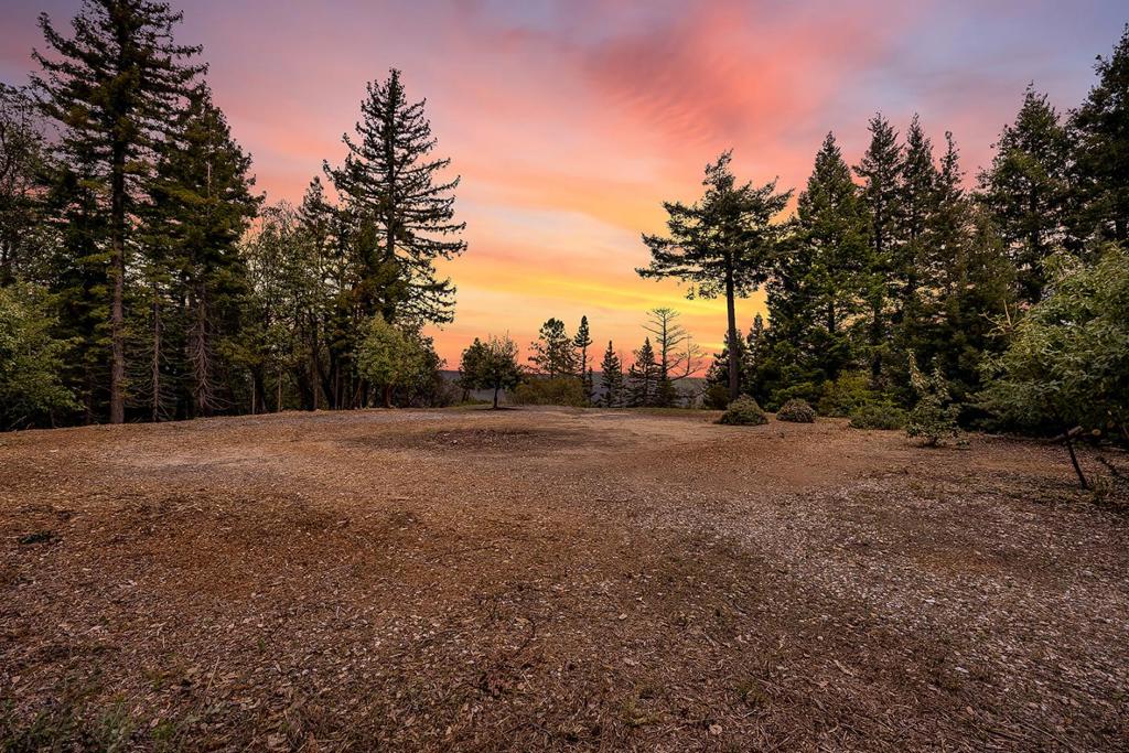 Perched atop Empire Grade, Feather Lane is a path to peace and solitude. Your nearly 10 acre parcel affords a fifty mile view across canyons, hilltops and to mountains. This ready-to-build property includes an established well with adjacent well house, PG&E in place, and septic percolation tests from the owner's initial preparation for construction. Most notably, there is a flat perfectly graded large building pad at the end of a wide packed entry road. The owner cleared a private spot above the primary building area that could contain a cottage, artist studio, or even a larger ADU. There is a year round creek on the Northern boundary, which borders Fall Creek State Park, seemingly making your parcel thousands of acres larger. Build to 4000+ SF, or a getaway smaller home. Your opportunities abound. There are rolling slopes for walkways and paths. Your unobstructed view corridor is across your land. Also, there are four main roads down the mountain within one mile of your front gate.