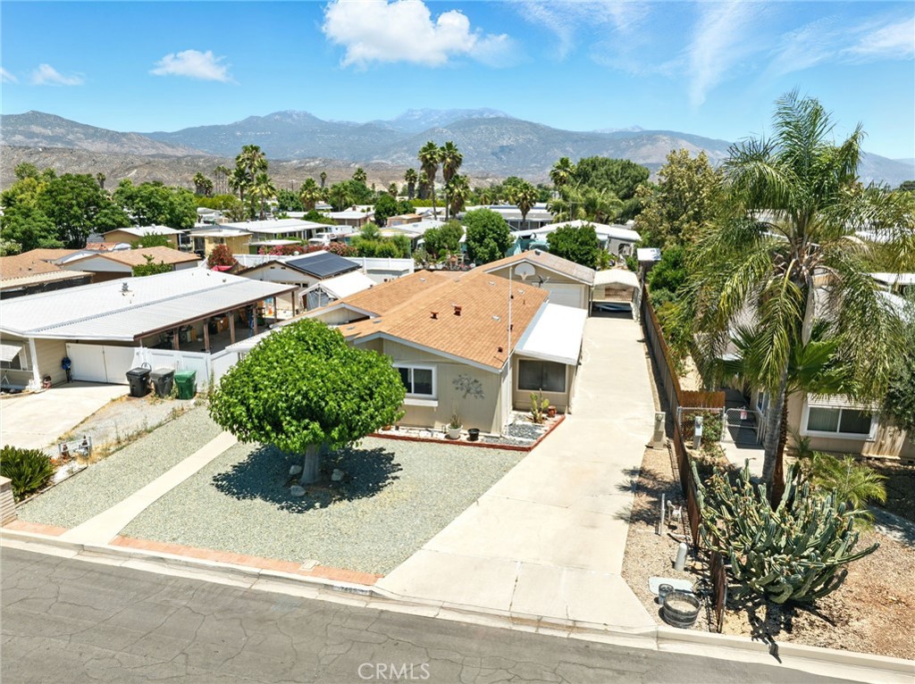 Welcome home to 24892 Rosebrugh Lane! This beautiful Silvercrest built manufactured home offers quality living at a great price. Located in a quiet pocket of East Hemet with quick access to Florida Avenue and Ramona Expressway ideal for commuters. This extra spacious home offers quality construction of 2x6 walls, a 433 "permanent" foundation, drywall interior and dual pane vinyl windows. A major highlight is the detached two car garage PLUS covered parking for a total of 3 spaces, and a large enclosed workshop. The inside features three bedrooms plus a den that could be used as a 4th bedroom or office space and offers so much storage. Down the side you have a nice concrete driveway that could be used for RV parking and there are hookups to stay plugged in or host RV guests. The huge kitchen offers lots of storage, granite countertops and a walk in secondary area that could be used as a mudroom or pantry area. The master bedroom offers a large living area, en suite bath, walk in closet and enclosed patio room area for retreat or storage. There are two water heaters on the property and the HVAC is oversized for the home and late model. With a low tax rate, no HOA and no solar liens to assume this is an affordable home for all! Schedule your showing today!