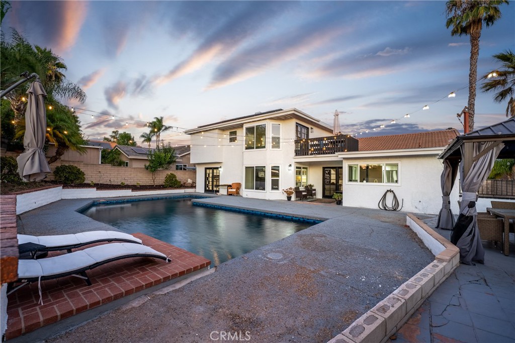 This beautifully renovated home features three private bedroom suites, each with its own remodeled bathroom complete with dual sinks and walk-in showers. One suite is conveniently located downstairs, while the main suite and another suite are upstairs. The main suite offers a fireplace, walk-in closet, vanity, bay window overlooking the pool, French doors to a private balcony, and a luxurious bathroom with a freestanding tub and walk-in shower. Double doors open to a high-ceiling entry and a bright living room with a fireplace, seamlessly connecting to the dining area. The updated kitchen opens to a spacious family room with a wet bar and fireplace, while French doors lead to a sparkling pool and spa with new plaster and tile. The backyard includes a covered patio and built-in BBQ, making it ideal for entertaining. Additional upgrades include fresh paint inside and out, recessed lighting, new bay windows, French doors, new flooring, quartz countertops, and backsplash enhancements. This turnkey home also comes with solar, no Mello Roos, and no HOA.
