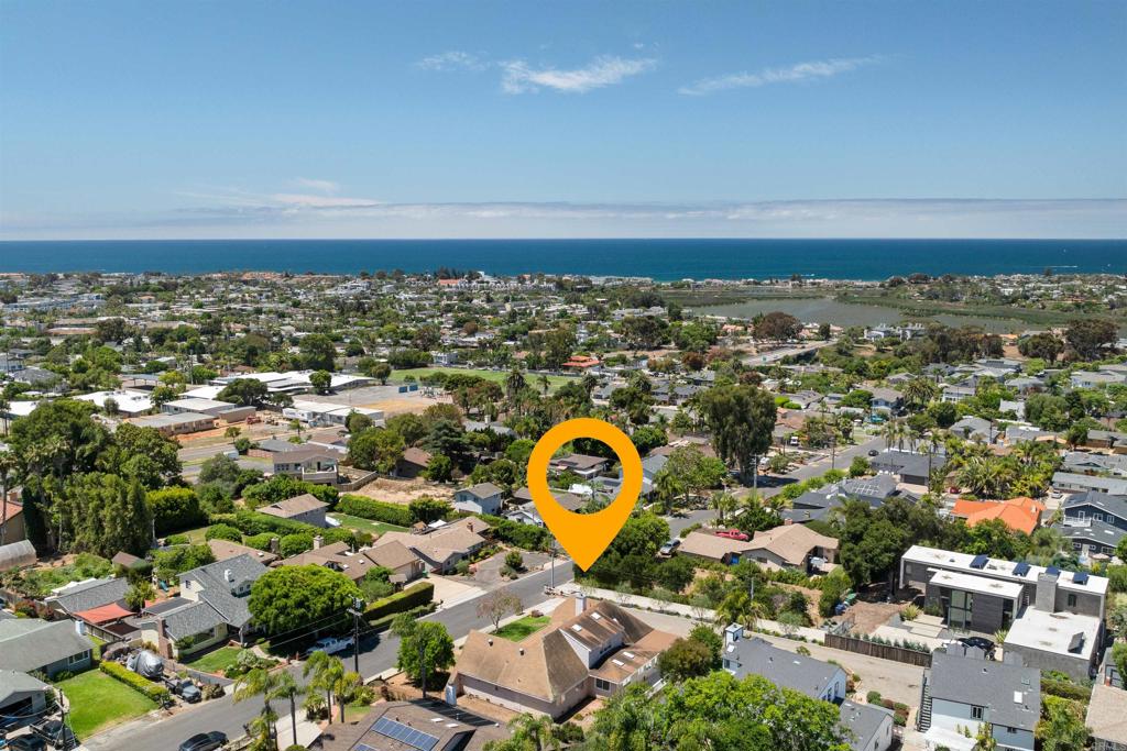 Ocean Views, Endless Potential, and a Prime Carlsbad Location Nestled just minutes from the vibrant heart of downtown Carlsbad, this unique coastal property offers ocean views, cooling sea breezes, and exceptional space—inside and out. Making its debut on the market for the first time since it was built in 1986, the residence presents a rare opportunity to infuse your personal vision and style into a truly special home. Prominently situated with approximately 108 feet of street frontage, the home is framed by an expansive front yard and boasts standout curb appeal in the neighborhood. Inside, the generous open floor plan includes three bedrooms and three bathrooms all on the main level, thoughtfully laid out for both privacy and functionality—ideal for families or multi-generational living. The large kitchen is designed with entertaining in mind, featuring two sink/prep areas and an oversized island, while hardwood flooring and dual-pane casement windows bring warmth and efficiency to the space. A standout feature is the spacious second-level loft, perfect as a media room, studio, or home office. Just beyond, an undeveloped attic area offers an exciting opportunity for expansion—ready for your imagination to shape it into a new living space, gym, or creative retreat. The enclosed rear patio with adjacent decking opens to a sizeable, underutilized portion of the yard—ideal for transforming into a private outdoor entertaining area or garden oasis. Perched on a gentle rise, the home captures stunning ocean breezes year-round, enhancing the serene Southern California lifestyle.
