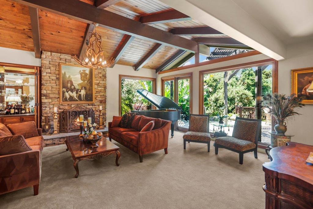 Large one-level floor plan professionally designed for both family and entertaining in coveted Dos Palos. At the heart of the home, a large chefs kitchen has 2 Sub-zero refrigerators, 2 Dish Drawers, under-counter ice maker and warming drawer integrated seamlessly into the bespoke hardwood cabinetry. Gorgeous wood-paneled dining room doubles as a media/game room (moving panels reveal widescreen wired for surround sound). Primary bedroom suite offers 2 large walk-in closets and a spa-like bathroom with built-in dressers and vanity. Public rooms have vaulted/beamed ceilings and picture windows offering views to the wooded open space adjoining the property across the creek. Gardens tropical foliage, stone terrace, grass, and decks are ideal for both entertaining and children. Dual driveways accommodate plentiful parking. Close to Los Altos downtown & its excellent private/public schools. Quick access to major Silicon Valley freeways for easy commute to the tech giants and shopping.