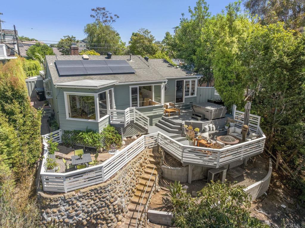 For those who crave privacy and a connection to nature without giving up the vibrancy of San Diego city life, this North Mission Hills home embodies it all. Set behind a private courtyard, is a 1938 canyon bungalow, designed by famed architect Lillian Rice, showcasing her philosophy that patios and decks should dissolve the boundaries between home and nature. Inside, oak floors, a wall of windows framing the canyon, a rebuilt fireplace, original built ins, and an open kitchen with Sub-Zero refrigeration, Miele dishwasher, and Bertazzoni range create a light-filled yet cozy living environment. The primary bedroom opens directly to the back deck for an immersive nature experience, while the bathroom has been thoughtfully refreshed within the past four years. Modern comforts include a 2-car garage, whole house water purification, newer water heater, central heating and air, complemented by the efficiency of owned solar sufficient to power electric vehicles. Centrally located, the home is steps from neighborhood cafés, village-style shopping, top-rated Grant (TK-8), and Pioneer Park, with Downtown, Old Town, San Diego Bay, and the region’s finest beaches only minutes away. Whether savoring the vibrant community nearby or retreating into the quiet privacy of your canyon retreat, this residence exemplifies the best of San Diego’s urban–coastal lifestyle.