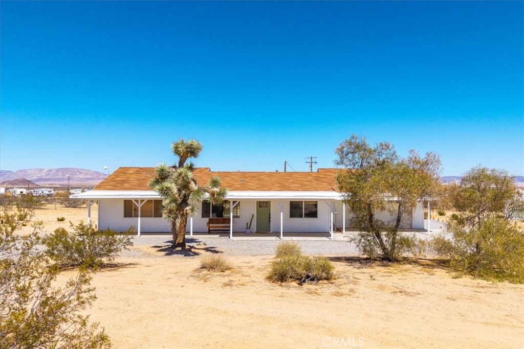 Tucked away in the peaceful expanse of the Mojave, Moonstone Mesa is a fully remodeled, fully furnished desert gem offering a rare blend of privacy, modern comfort, and iconic High Desert beauty. This stunning 2-bedroom, 2-bathroom home is situated on just over 2 acres of fully fenced land, directly adjacent to more than 100 acres of untouched Bureau of Land Management (BLM) land, ensuring uninterrupted views, total seclusion, and a direct connection to the raw beauty of the surrounding landscape. Thoughtfully redesigned from the inside out, the home features a remodeled kitchen with warm custom woodblock countertops with a clean, minimalist aesthetic that complements the desert surroundings. Both bathrooms have been tastefully updated with stylish, modern finishes, and the freshly painted eaves reflect the home’s excellent maintenance and turnkey condition. Step outside and the magic continues. A custom-built patio cover offers shade and comfort for outdoor lounging, while the spa provides a relaxing place to soak under the stars. A custom-built shed expands your options—perfect for a creative studio, extra sleeping space, or a private retreat. Enjoy sweeping mountain views by day and some of the clearest night skies in the region, ideal for stargazing or simply unwinding by a fire pit. The property also includes a spacious attached two-car garage along with curated desert-inspired decor included in the sale—making this a true turnkey opportunity, whether you're seeking a primary residence, vacation home, or income-generating investment. Currently operating as a successful short-term vacation rental in the High Desert, Moonstone Mesa has a proven track record and outstanding guest reviews. Its strategic location—just minutes from Joshua Tree, Joshua Tree National Park, Pioneertown, Yucca Valley, and a short scenic drive to Palm Springs—makes it both a sought-after rental and a peaceful private sanctuary. Whether you're drawn to the tranquility of desert living or the potential of a well-established Airbnb, Moonstone Mesa offers a rare opportunity to own a piece of the High Desert dream—fully furnished, beautifully remodeled, and ready for your next adventure.