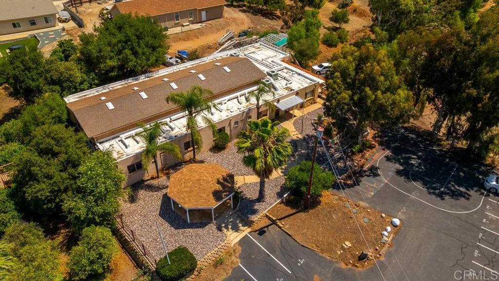 Premier Investment Opportunity with Exceptional Cash Flow Potential! Discover 9780 Dunbar Ln, El Cajon, CA 92021, a sprawling single-story estate featuring 10 bedrooms, 14 bathrooms, and 6,909 sq ft of living space on a vast 107,593 sq ft lot (approx. 2.47 acres). Previously operated as a Residential Care Facility, this property is a turnkey investment for those seeking strong cash flow through continued use as an RCF, conversion to another care facility, or alternative ventures such as a retreat center, multi-family compound, or development project. Versatile Layout: Spacious interior with functional amenities, including large dining areas, classroom spaces, and multiple offices, ideal for operational flexibility or reconfiguration. Expansive Grounds: Includes a private soccer field, orchard, and ample open space, offering opportunities for recreational enhancements, additional development, or agricultural income. Prime Location: Situated in a serene neighborhood, minutes from schools, parks, shopping, and major freeways, ensuring accessibility and appeal for various uses. Modern Features: Equipped with a contemporary kitchen featuring stainless steel appliances, granite countertops, energy-efficient windows, and central AC, reducing maintenance costs. Development Potential: The 2.47-acre lot provides room for expansion, additional units, or alternative projects, subject to county approval, maximizing ROI. This estate’s size, amenities, and location make it a rare find for investors seeking high-yield opportunities. Whether maintaining its current use or reimagining the property for new ventures, this property offers unmatched potential for substantial cash flow. Contact us today to schedule a private tour and explore this lucrative investment!