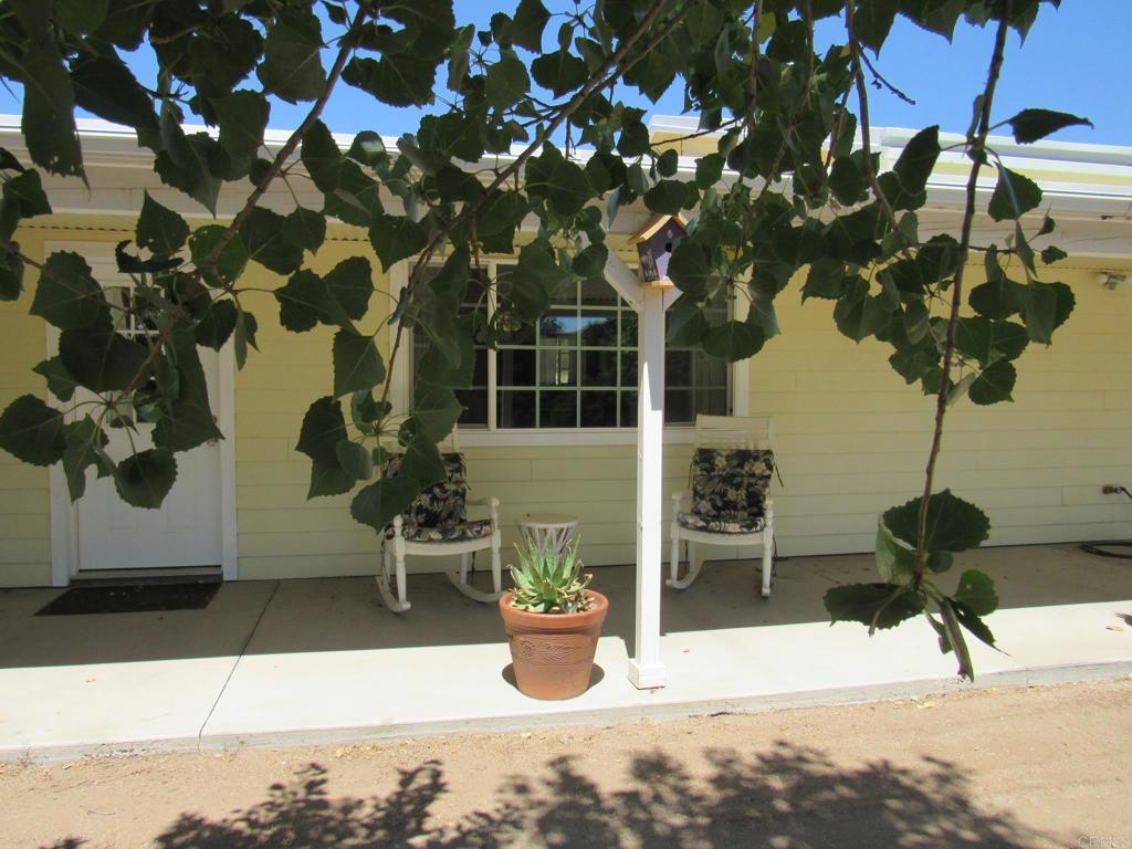 Rocking Chairs convey! Imagine yourself sipping your morning brew out on your private porch that extends the entire length of the home. Come back for a cool drink in the evening. The porch is what it's all about. You've probably driven past this property hundreds of times and never knew it was there. There is a thick scrub oak buffer on the road that offers complete privacy. This 3 BD, 2 BA home was custom built by the current owner, with an oversized 2 car garage, a 50' x 30' metal barn and a nifty shed complete with a hot tub that also conveys. The spacious living area entails a "great room" style kitchen, dining, and family room. Attached oversized garage is insulated and drywalled 2x6 walls (R-19) and (R-38) in the ceiling. The floor is finished with a tough epoxy coating. The home is auto sprinkled and metal roof combined with the hardy board siding makes this home fire resistant. The plumbing is all copper and the furnace is brand new. Ceiling fans in all the rooms and dual pane windows keep the home temperate in all seasons. The view from your rocking chairs includes apple, plum, apricot, nectarine and an orange tree as well as several other species of mature trees. Just beside the house is a green house/chicken coop, to tickle your imagination.