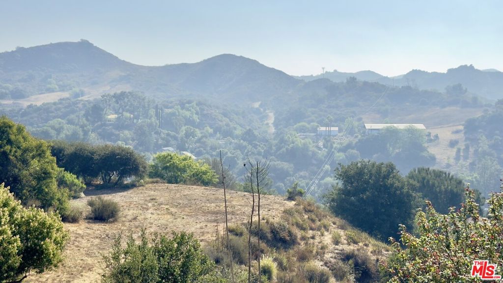 Discover a builder's dream at 2152 N Topanga Canyon Blvd, nestled in the enchanting landscape of Topanga, CA. This expansive 1.8-acre land parcel, boasting a generous 77,452 square feet, is primed for visionaries eager to create an exclusive retreat or a luxury residence with potential for breathtaking panoramic canyon vistas. The property features two substantial flat pads that provide an ideal foundation for construction. Privacy is paramount here, with the land's seclusion ensuring a tranquil environment for future residents. Builders and investors will appreciate the lack of oak trees, streamlining the development process and eliminating common obstacles. With LCA11Y zoning, the possibilities are endless. Seize this rare opportunity to craft a masterpiece in one of California's most coveted locales.