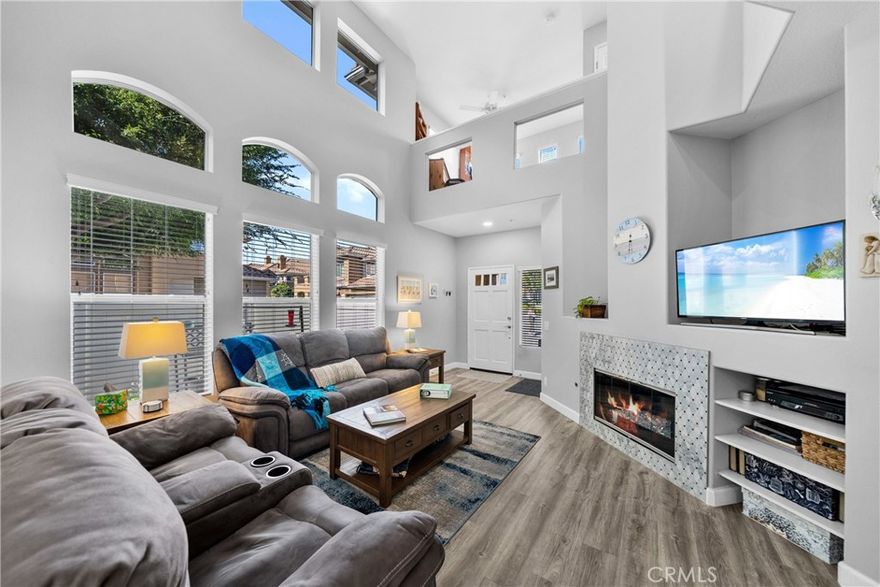 Welcome to 122 Valley View Terrace, a beautifully updated end unit townhome perfectly situated in one of Mission Viejo’s most desirable communities. This spacious residence offers 2 bedrooms plus a versatile loft that can easily be converted into a 3rd bedroom — ideal for a home office, guest space, or play area. Step inside to a bright, open floor plan with dramatic two-story ceilings in the living room, creating an airy and inviting atmosphere. This home has been meticulously well cared for, showcasing a remodeled kitchen, upgraded bathrooms, a cozy fireplace, newer blinds, and central air conditioning for year-round comfort. The private patio is perfect for outdoor dining or morning coffee, surrounded by lush, well-maintained landscaping. The primary suite is a true retreat, featuring a spacious walk-in closet and a remodeled ensuite bathroom with a walk-in shower and dual sinks. An attached 2-car garage provides ample storage and is equipped with an electric car charger for added convenience. Residents enjoy access to a saltwater pool and jacuzzi as well as Lake Mission Viejo, where summer concerts, boating, and lagoon fun await year-round. Additional highlights include low HOA dues, ample guest parking, and easy access to shopping, dining, entertainment, and transportation. This move-in ready home blends modern upgrades with an unbeatable location — offering the best of Mission Viejo living.