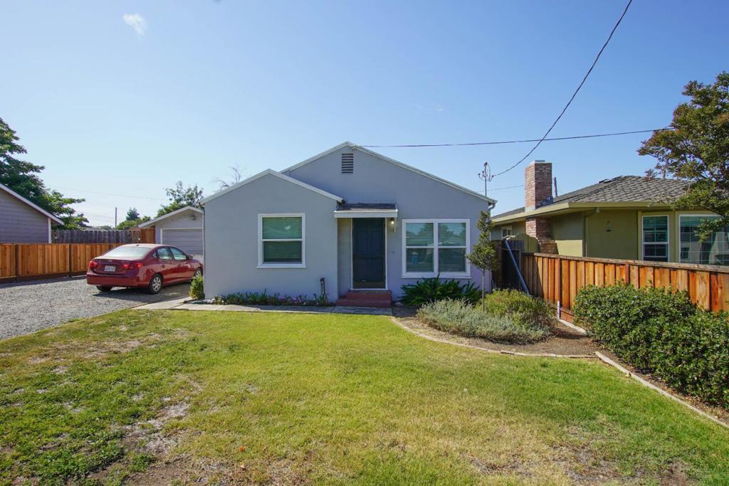 Welcome to this charming 3-bedroom, 1-bathroom home located in Hollister. Sitting on a spacious lot of over 7,400 square feet, this residence offers a comfortable living space of 985 square feet. The kitchen is well-equipped with modern appliances, including a gas oven range, microwave, and dishwasher, making it ideal for your culinary endeavors. Enjoy meals in the cozy eat-in kitchen area.The kitchen has beautiful newer cabinets and a farmers sink with a custom wood cutting board. The home features beautiful hickory hardwood flooring throughout, adding warmth and character. The property also includes a convenient inside laundry area with 220V electricity hookup. There are garden boxes all ready for your gardening and a fun swing set for the adventurous. After all the yard work and play unwind in the spa/hot tub, perfect for relaxation in the back yard. Don't miss out on this wonderful opportunity!