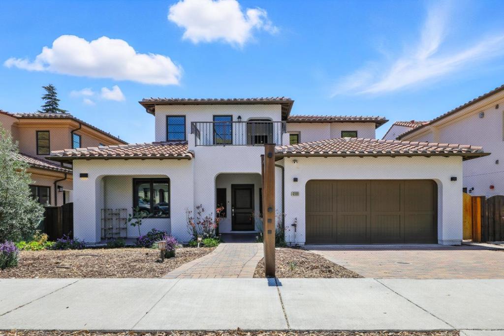 Welcome to this Spanish-style luxury home nestled against the scenic foothills of Fremonts highly sought-after Mission District! With NO HOA ! The main level boasts a private en-suite bedroom with soaring 12-foot ceilings, ideal for guests or multi-generational living. The gourmet kitchen impresses with a sleek Quartz waterfall island, SS appliances, and a generous walk-in pantry. It flows seamlessly into the expansive living space and a bright enclosed sunroom, perfect for year-round enjoyment. Additional features include a well-appointed mudroom, a stylish half bath, and a 3-car finished garage equipped with EV charging outlets. The home also offers dual-zone central heating and cooling, elegant whole-house custom window treatments, and high-end built-in cabinetry in the den. Upstairs, a spacious loft landing opens to a balcony with tranquil hillside views. The primary suite serves as a luxurious retreat, complete with a soaking tub, separate shower, dual vanities, and a walk-in closet. Three additional bedrooms each include en-suite or nearby baths, and the full laundry room adds everyday convenience. Situated close to major freeways, shopping, and dining, this exceptional property offers location, luxury, and lifestyle in one of Fremont's most prestigious neighborhoods.