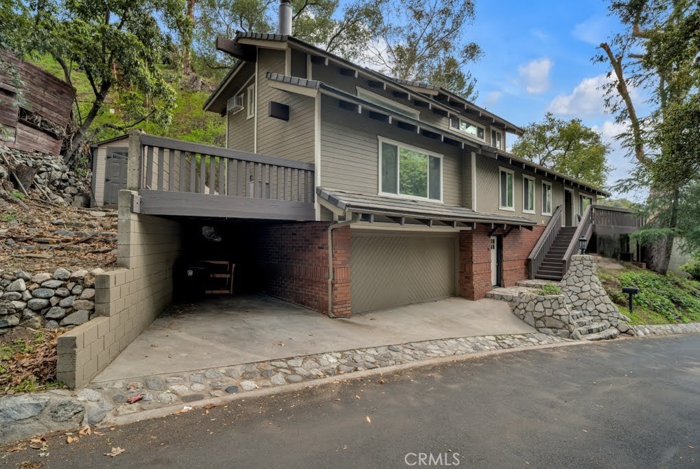 Always Dreamed of Living in a Treehouse? Dreams Do Come True. Tucked into the tranquil Verdugo Mountains above Burbank, this inspired 2,700 sq. ft. architectural retreat offers the perfect blend of serenity, style, and flexibility. With 3+ bedrooms and 4 full bathrooms, this light-filled home feels more like a modern treehouse sanctuary than a traditional residence. Soaring 20-foot ceilings, dramatic skylights, and natural wood beam details bathe the interiors in warmth and light. The open-concept living space is both cozy and expansive—with two separate living spaces - ideal for slow mornings, inspired work sessions, or intimate evenings by the fireplace. The chef’s kitchen is a showstopper, featuring Brazilian Quartzite counters and custom-paneled appliances by Miele, Jenn-Air, and Dacor—a dream for culinary creatives and entertainers alike. The layout offers ideal flexibility: Main level: Spacious bedroom with ensuite bathroom. Upper level: Dreamy primary retreat with spa-style bath and private rooftop deck—perfect for sketching at sunrise, reading under the trees, or stargazing. Second bedroom or office space with privacy and views. Street level: Private entrance to bonus room with ¾ bath—perfect for a home office, guest quarters, or creative studio. Open the patio doors and let the canyon breeze stir your senses—this is where nature and imagination coexist in harmony. Located on peaceful Country Club Drive, you're just minutes from Burbank’s studios, cafes, and creative community, yet it feels like a world away. With a garage (EV charger-equipped), carport, and timeless details throughout, this is a rare chance to live—or lease—in a truly inspired hillside home. The following appliances are included: stove, refrigerator, dishwasher, microwave, clothes washer, and clothes dryer. Tenant to maintain included appliances. Tenant pays all utilities. Will consider pets. Excellent credit and 2 1/2 times the income is required.