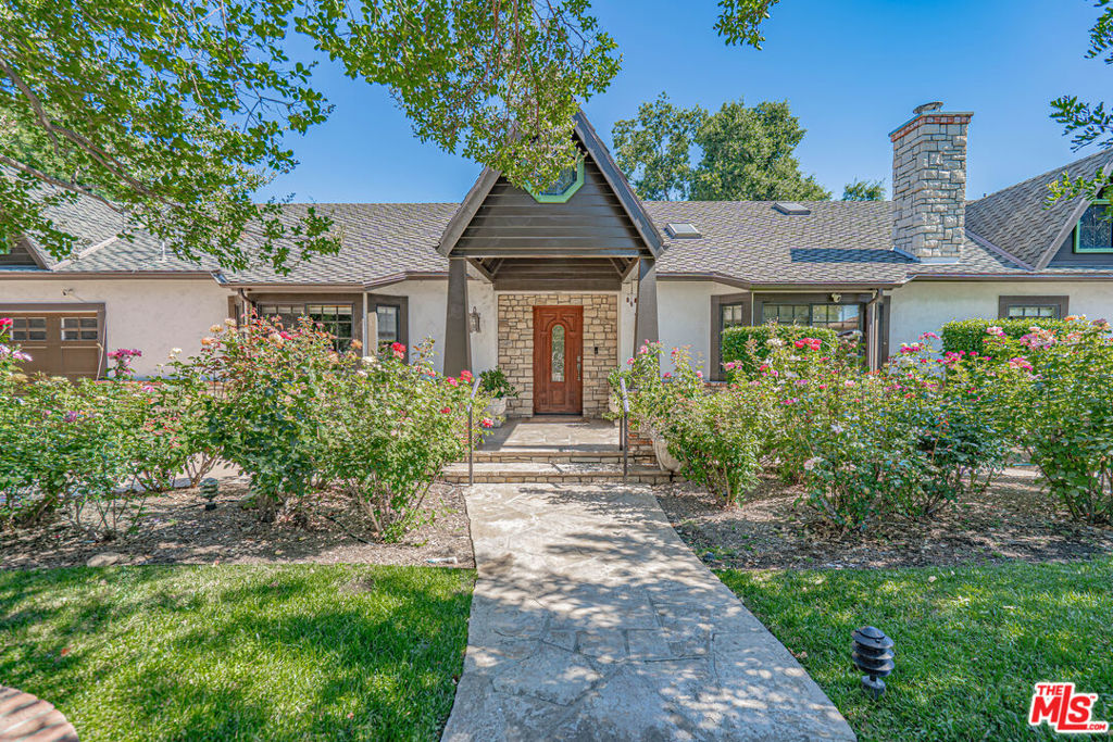 Homesteader & Creative's Dream Estate; Just under an acre and ideal for a Family Compound. This 4,548 sq. ft. Double gated estate in the heart of Walnut Acres, blending privacy, luxury, and the opportunity for self-sufficient living and artistic expression. Fully paid off Solar, 40 KWH per day, upgraded inverters 2021 400AMP power, Newer roof, Whole House fan, water filter and softener, Two - Five ton 3 zone HVAC units installed 2022, New Designed for those who value craftsmanship, sustainability, and inspired living. Canadian Heart Pine, Custom cabinetry with bull nose moldings custom copper sinks and hood Newer Milguard windows and sliders throughout. . This property offers endless possibilities. The main home features 3 bedrooms and 2.5 bathrooms, with the primary in its own wing of the home creating that needed separation from the rest of the house. The chef's kitchen is both functional and elegant, boasting a large center island with additional prep sink and custom seating, handcrafted COPPER range hood, copper SINK and accents, custom cabinetry, high-end appliances, and a HUGE walk-in pantry. A built-in desk for workspace functionality, adjacent to the laundry room and wood-lined linen / storage room, adds to the home's thoughtful design. A vintage Chicago bar (circa 1927), meticulously restored and off the formal dining room which faces the vintage wine rack custom made from terracotta pipes. The homes seamless flow leads into the private home theater, complete with plush reclining seating, built-in surround sound and elegant wainscot detailing. After dinner and cocktails, step outside to the expansive covered pavilion, exposed beams, stone fireplace, sets the perfect space for ultimate relaxation under the stars. Elegant lighting, gas hook-ups for BBQ enthusiast adding to the grand entertainer's lifestyle. Off the rear of the house with a separate entrance leads to the attached 1-bedroom, 1-bathroom guest suite built in 2023 with its own private laundry room which creates the perfect amount of privacy for multi-generational living. Long, gated driveway leads to an ample parking and additional storage for all your tools and toys. The 1,800 sq. ft. 8-car garage has commercial grade power, new roof installed 2021, ideal for a workshop, artist's studio, creative space, or potential, ADU conversion. Leaving an additional Single-car garage attached to the main house. The rear yard offering ample space and privacy consists of an Orchard, including Meyer and regular Lemons Blood Oranges, Lime, Kava Kava, Oranges Peach, Nectarine, Apricots, Pluots, Finger Lime, Pomegranates, Black Walnuts and more. Not to mention the raised garden beds and multiple above-ground planters for growing fresh produce all year round, Coop for fresh eggs $$$$, Pool with a wood deck for ultimate relaxation. This estate is perfect for multiple situations let your imagination flow. Animal friendly property, horse or race cars, this private family compound, has it all. Multi-generational retreat, self sufficiency or an inspired lifestyle. Let your dreams come true. Just under an acre of land, the possibilities are endless. DO NOT miss this amazing opportunity.