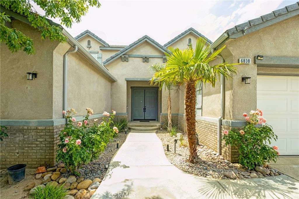 Welcome to your dream home—a stunning two-story sanctuary that is all about comfort and thoughtful design at every turn. From the moment you step through the grand entrance, you're greeted by soaring ceilings, a dramatic round staircase, and an abundance of natural light, all enhanced by elegant recessed lighting. The first floor offers an ideal blend of formal and casual living spaces, featuring a beautiful living room, a spacious dining room perfect for hosting, and a warm and inviting family room centered around a built-in fireplace. Whether you're entertaining guests or enjoying quiet evenings at home, this layout provides the perfect backdrop for every occasion. At the heart of the home is a gourmet kitchen that will delight any chef—complete with granite countertops, high-end stainless steel appliances, a huge walk-in pantry, double ovens, two sinks, and a mini wine cooler. The open-concept design flows effortlessly into the living and dining areas, creating a welcoming atmosphere for family and friends alike. Also on the main level is a versatile flex room that can be customized as a home office, gym, or private theater. A full bathroom and a separate laundry room with built-in cabinetry add everyday convenience and functionality. Upstairs, escape to a luxurious master suite featuring an expansive bedroom, dual walk-in closets for him and her, and a spa-inspired bathroom with dual vanities—your own private retreat. Three additional generously sized bedrooms, each with their own walk-in closet, share a beautifully appointed full bath. Step outside into your private backyard, where a built-in barbecue and grill area await—perfect for weekend gatherings, evening dinners, or simply unwinding under the stars in peace and comfort. Every detail of this exceptional home has been designed for the ultimate lifestyle. It’s more than a place to live—it’s where memories are made and dreams come to life.