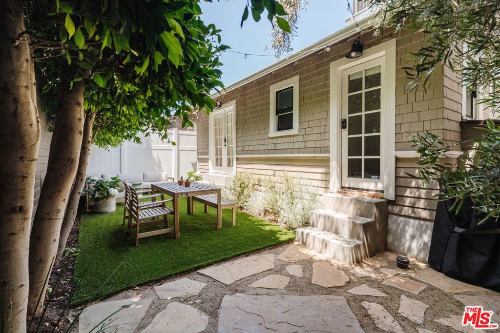 Experience effortless coastal charm just steps from Abbot Kinney and the beach at this curated Venice Beach bungalow with timeless character with high-end finishes. This curated home offers 2 bedrooms, 1 bathroom, and 1,072 SF of living space on a 1,528 SF lot, showcasing classic craftsmanship throughout and a private backyard oasis perfect for relaxing and entertaining guests. An inviting front deck welcomes you to the home and opens up to a bright, thoughtfully designed interior featuring oak hardwood floors, tongue-and-groove coffered ceilings, and extensive wainscoting. The gourmet kitchen boasts custom cabinetry, marble countertops, and top-of-the-line stainless steel appliances. A well-appointed mudroom adds function and charm with built-in storage, while chic lighting and curated fixtures elevate the entire space. The primary bedroom features skylights and French doors opening to the private sunlit backyard, ideal for relaxing after a day at the beach. A newly remodeled bath with a wide-tile floor and bespoke vanity complete the interior. Upstairs, you'll find additional storage and a spacious second bedroom that also functions as a bonus flex space great for a home office, guest room, or creative studio. With dedicated space for bikes and boards and quick access to the beach, farmers markets, Main Street, and Abbot Kinney, this refined beach bungalow offers idyllic laid-back coastal living in the heart of Venice. Property is also listed for lease at $7,000/mo.