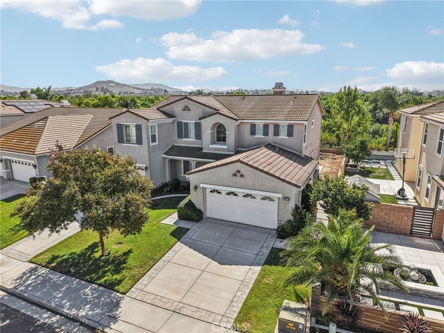Unmatched Views & Energy Independence!



This Eastvale home is a true standout, offering style, space, VIEWS, and modern efficiency with paid-off solar panels and two Tesla backup batteries—providing peace of mind, energy savings, and reliable power.







From the moment you arrive, the curb appeal impresses with a lush green lawn and manicured landscaping. Inside, you’re welcomed by a tiled entry and an open-railing staircase. To the left is a formal dining room that can double as a home office or playroom, and to the right, a formal living room.







At the heart of the home is the expansive family room with a cozy fireplace and media niche, seamlessly connected to the open kitchen. The chef’s kitchen offers abundant cabinetry, granite countertops, a built-in cooktop, double oven, large center island, and breakfast nook. Sliding glass doors lead to the backyard for effortless indoor-outdoor living. The main floor also includes a bedroom and full bathroom, and a laundry room with a sink and cabinetry.







Upstairs, the primary suite captures sweeping views of the Santa Ana River and surrounding greenbelt. The spa-inspired bathroom includes dual sinks, a soaking tub, walk-in shower, and a spacious walk-in closet. Four additional bedrooms and two more bathrooms provide plenty of room for family and guests. Plantation shutters throughout add a touch of elegance.







The backyard is designed for both relaxation and entertaining, with a covered patio, stamped concrete, a large grassy area, and breathtaking greenbelt views that make every day feel serene.







With its unobstructed views, fully paid-off solar system, and two Tesla Powerwall batteries, this home combines natural beauty with energy-smart living—a rare find that delivers comfort, savings, and sustainability.