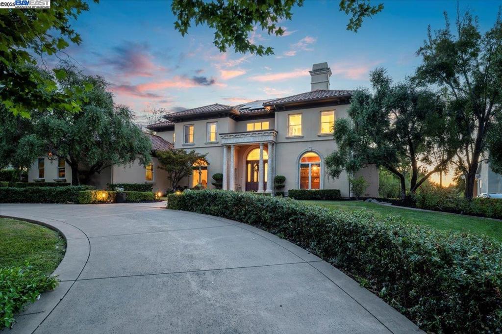 Located in one of Pleasanton's most sought-after luxury gated communities of Ruby Hill. This custom luxury home welcomes you with warm mahogany floors and a grand staircase. 5 bedrooms, 4.5 bathrooms, and 5,411 square feet of beautifully designed living space. The spacious kitchen features a center island, desk area and abundant cabinetry. Opening to the family room and a separate dining area, perfect for entertaining. Additional highlights include a downstairs office, an entertainment room with motorized detracting movie screen and ceiling projector along with a fireplace and full bathroom. A downstairs bedroom suite, and a large laundry room. The luxurious primary suite features an expansive walk in closet with a dual built - in dresser and a dressing area complimented with a spa-inspired bathroom. Step outside to a serene backyard with professional landscaping, a custom pergola, along with an inground gated pool and spa. Energy efficiency is enhanced by fully owned solar panels. Other features include a 3-car garage. Enjoy access to Ruby Hill’s exclusive amenities, including a clubhouse, tennis courts, and 24-hour security.
