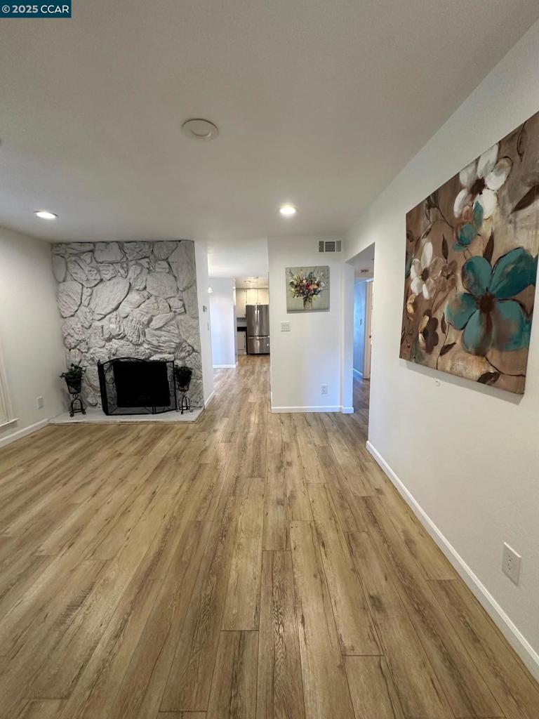 Experience comfort, convenience, and style in this stunning second-floor condo ideally situated near shopping, dining, parks, and with easy access to I-680 and 242. This inviting home offers two spacious bedrooms and 1.5 baths, located just steps from the elevator for added ease—or take the nearby stairs if you prefer. Inside, enjoy the practicality of in-unit laundry, the warmth of laminated flooring throughout, cozy living room with fireplace, and a private patio perfect for relaxing. The modern kitchen boasts sleek quartz countertops and an abundance of natural light. Set within a secure gated community featuring a community pool in a sought-after location—making it a perfect place to call home.