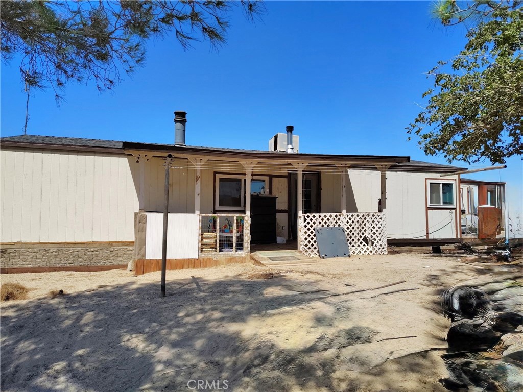 An exciting investment opportunity in Newberry Springs.
This property features a spacious 1,920 sq ft manufactured home with two bedrooms, two bathrooms, a bonus room with a fireplace, and an indoor laundry room. It also includes a wood stove, new windows, a new septic tank, new water heater and a new porch. The home runs on propane and has its own well, situated on a generous two-acre lot. Please note that the home is not yet on a permanent foundation and requires significant tender loving care (TLC). The street access is unpaved. Due to the current condition of the manufactured home, this will be a cash-only offer.
This property offers tremendous potential for the right investor