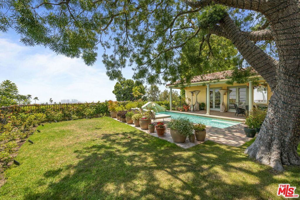 Secluded European Villa Style 4 bed/4.5 bath on private cul-de-sac in the desired Crest Streets with breathtaking panoramic views from downtown to coastline. Enter grand foyer with large arched windows and openness overlooking backyard greenery and city views. Open floor plan filled with natural light throughout, with spacious living and dining rooms that included vaulted ceilings, fireplace, custom built-ins and wall of French doors opening to magical backyard with tiled patios, mature landscape, relaxing sunny pool with water feature and endless views. Gourmet kitchen off dining room with butcher-block countertops, center island, double ovens, Viking gas range with grill, large pantry off kitchen and charming breakfast room. Just off of the entry area is an inviting den/office with fireplace and French doors to backyard and leads to separate wing with beautiful primary suite with French doors overlooking pool, double custom walk-in closets and marble finished primary bathroom with dual basins and separate spa bath and shower. 3 additional bedrooms, all with en-suite updated bathrooms. 2 of the bedrooms include French doors to private tiled balconies with stunning city views. Additional features include honed marble flooring, multi-zone skylights throughout, ac/heat, direct access garage, inside laundry room with storage off kitchen. Close proximity to world-class Beverly Hills and West Hollywood restaurants and retail. A truly unique opportunity that offers a tranquil retreat just minutes from the city.