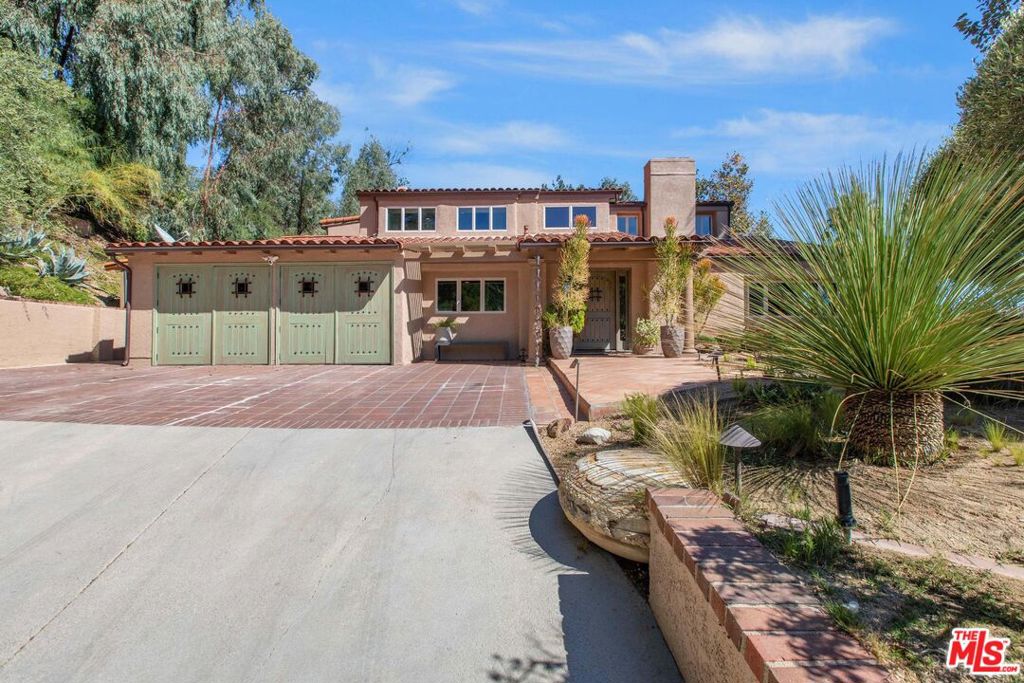 A stunning blend of Spanish elegance and modern Calabasas living, nestled in the prestigious guard-gated community of Vista Pointe. This beautifully upgraded 4-bedroom, 3.5-bath home with an additional bonus room offers sweeping views and refined design throughout. Step inside to a chef's dream kitchen, featuring dramatic rainforest granite countertops, custom cabinetry, and a professional-grade Wolf 60" double oven range with griddle and island hood. Slate floors flow through the main level, where both the living and family rooms offer cozy gas fireplaces, ideal for entertaining or relaxing. The formal dining room is a showstopper, with crown molding and a striking wrought-iron chandelier. A first-floor bedroom suite provides the perfect guest quarters or private office. Upstairs, the luxurious primary suite features Cypress hardwood floors, a fireplace, sitting room, and private balcony with panoramic canyon views. The spa-like primary bathroom includes a free-standing tub, oversized glass shower with multiple heads, double vanity, and a spacious walk-in closet. Two additional upstairs bedrooms share a chic Jack & Jill bathroom with a sunken Jacuzzi tub and walk-in shower. Outside, enjoy drought-tolerant landscaping, copper gutters, and statillo tile. The backyard offers a tranquil retreat with a separate BBQ area, scenic viewing deck, and a large grotto spa perfect for soaking under the stars. This exceptional home combines Spanish-inspired design with modern amenities in one of Calabasas' most sought-after neighborhoods. Don't miss the chance to lease this view-filled sanctuary in Vista Pointe.