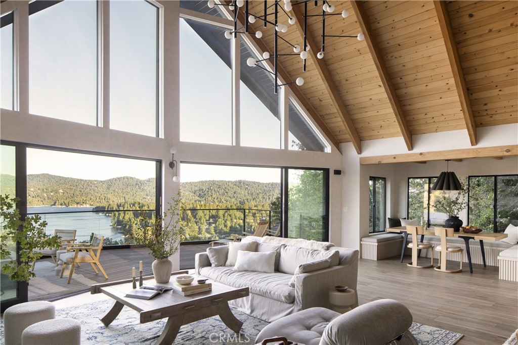 Wake up to incredible lake and mountain views every day. Imagine waking up to the serene beauty of shimmering lake waters and majestic mountain peaks stretching endlessly before you. This isn't just a home, it's a sanctuary where nature's grandeur meets architectural artistry.
Designed by a renowned firm, this 4,000 square foot residence embodies a blend of timeless elegance, bespoke craftsmanship and modern sophistication. With soaring A-frame ceilings and walls of glass, every room is bathed in natural light and framed by panoramic vistas that make you feel as though you're living within a painting.
The chef inspired kitchen boasts custom cabinetry, leathered marble countertops, and top tier appliances, seamlessly flowing into a living area anchored by a sculptural marble fireplace. Step outside onto the expansive deck, where the boundaries between indoor comfort and outdoor serenity blur, offering the perfect setting for both quiet mornings and lively gatherings.
Upstairs, a cozy loft continues the home's narrative of light and landscape. Downstairs, the primary suite unfolds with its own private deck, a spa inspired bath featuring a soaking tub and glass wrapped shower, and a custom walk-in closet. Nearby, a versatile bunk room and guest bedroom provide thoughtful flexibility. This amazing architectural residence can comfortably sleep 14 family and guests.
Entertainment is redefined on the lower level, where a built-in cinema with wet bar and 87? screen opens to a hot tub equipped with patio and outdoor kitchen, an entertainment sanctuary under the sky.
A newly completed ADU with a full bath, high end finishes and a full kitchenette completes this property and offers additional living space above the two-car garage with a private entry, all ideal for guests or multigenerational living.
This is more than a home: it’s a curated lifestyle in motion. Schedule your private tour today and experience firsthand the blend of nature and sophisticated design.