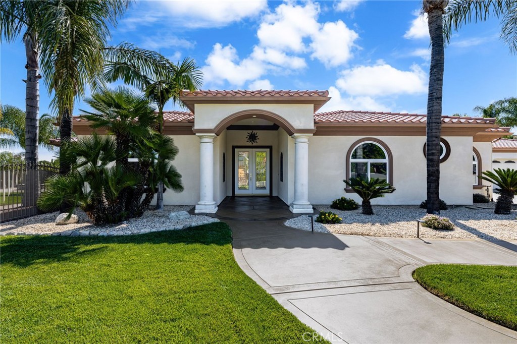 Welcome to the Beautifully Designed, Custom-Built 4,533 Square Foot Single-Story Home Located in a Small Cul-De-Sac in Desirable South Corona. Situated on an Expansive 40,000+ Square Foot Lot with NO HOA, this Property Offers Privacy, Space and Incredible Amenities. The Home's Standout Architectural Feature is the Striking Circular Formal Dining Area. There are 4 Spacious Bedrooms, Each with its Own Ensuite Bathroom, Plus a Convenient Half Bath off the Dining Area and a Spacious Office/Workout Room. The Luxurious Primary Suite Features an Oversized Walk-In Closet, and a Spa-Inspired Bathroom with Dual Sinks, a Vanity Area, a Soaking Tub and a Large Walk-In Shower. The Open-Concept Kitchen Flows into the Inviting Family room, Complete with a Gas Fireplace, High Hearth Mantle and Two Ceiling Fans. The Chef's Kitchen is Equipped with a Grand Walk-In Pantry, Stainless Steel KitchenAid Appliances -including a Built-In Refrigerator, Oven with 6 Burner Cooktop, a Single Oven, Microwave, Trash Compactor and Dishwasher. The Large Center Island has a Vast Amount of Storage and a Eating Area and Access to the Backyard. The Spacious Indoor Laundry Room Offer Ample Cabinets, a Utility Sink, Generous Counter Space and Direct Access to the Garage. Just off the Dining Area is the Game Room Featuring Custom Resin Countertops, Cabinets for Storage, Color-Changing Lighting, Bar Sink, Small Refrigerator, Built-In Media Cabinet, and a Sliding Door to the Outside Barbecue Area. Designed for Entertaining, the Backyard Includes Two Large Covered Patios, a Gas Fire Pit, Barbecue Island with Bar Seating, Sink, Mini Refrigerator, and Storage. There is a Sun Shade Area that is Great for Outdoor Seating or a Above Ground Spa. The Large Grass Area is Prepped for a Future Pool or Playground Area. Fruit Trees Include: 2 Dwarf Apples, Meyer Lemon, 2 Oranges, Tangerine, Avocado, Asian Pear, Nectarine and Lemon. Additional Amenities Include: Plantation Shutters Throughout Home, Mirrored Bedroom Closet Doors, Travertine Flooring, Carpet in Bedrooms and Family Room, Tinted Front Windows, Drought-Tolerant Landscaping, Rain Gutters, and Outdoor Motion Lights. The Property has a 2 Car Garage Plus a 4 Car Tandem Garage with Epoxy Floors, High Ceilings, Built-In Cabinets, RV Parking, Water Softener, and Hot Water Recirculation System. NO HOA, Low Taxes and Close to Award Winning Schools and Shopping. Truly a Remarkable Residence Where Detail and Design Come Together in Perfect Harmony.
