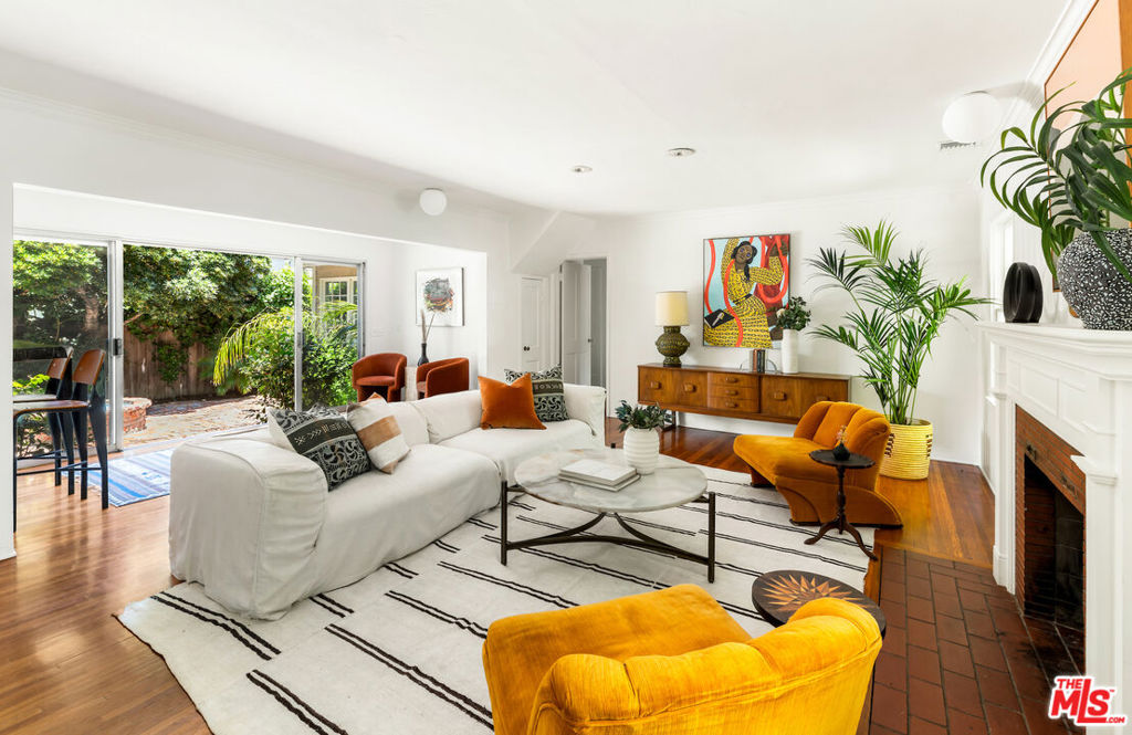 This captivating Toluca Lake pool home exudes enchantment throughout its design. The residence boasts three distinct outdoor areas: a grassy yard with a patio on one side, a charming central courtyard, and a lush backyard with a pool. The 1,865 sq ft home includes 2 spacious bedrooms on the ground floor, one of which opens to the backyard. The converted attic provides 1-2 additional rooms, ideal for another bedroom plus office or artist's studio. The living room, featuring a fireplace with wainscoting, hardwood floors, and built-in bookshelves, adds to the home's allure. Both bathrooms have been stylishly renovated. Two options for formal dining offer views of the gardens, and the remodeled kitchen includes a cozy eat-in nook perfect for breakfast. Additionally, a 195 sq ft detached studio overlooks the pool. Recent upgrades include a new HVAC split system, attic insulation, and completed termite and foundation work plus seismic retrofit upgrade. The large two-car garage on this over 8,000 sq ft corner lot has potential for transformation into an ADU. Situated in the well-rated Toluca Lake Elementary district, this home is conveniently located near all the amenities Toluca Lake has to offer.