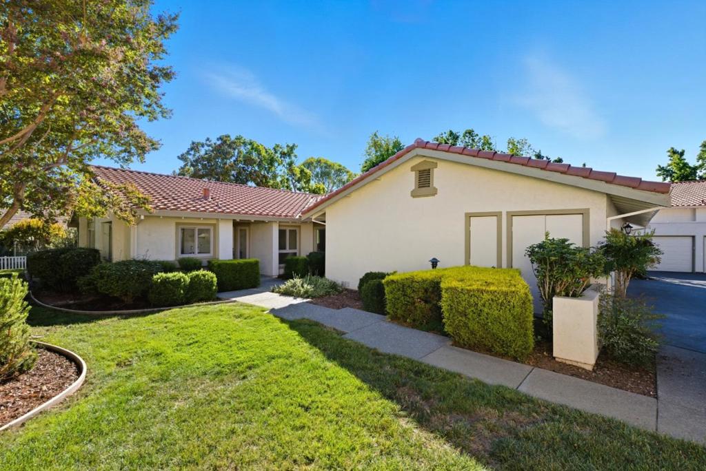 Located in the exclusive Villages Golf & Country Club 55+ community, this beautifully updated unit with new bathrooms and renovated kitchen (work done by licensed contractors) offers comfortable, single-level living with the convenience of 2 car garage. The office can be made into a 3rd bedroom. Nestled on a peaceful cul-de-sac in a gated community with 24/7 security. Enjoy a bright, open floor plan with high ceilings, a spacious living room with fireplace, and separate dining room accessing the outdoor area ideal for entertaining. The kitchen features quartz countertops and stainless steel appliances. The primary suite includes dual sinks and ample closet space. Relax on the private patio or explore the lush, resort-style grounds with golf, tennis, pickleball, bocce ball, 4 pools, fitness center, hiking trails, horse barn, clubs, restaurants, and more.