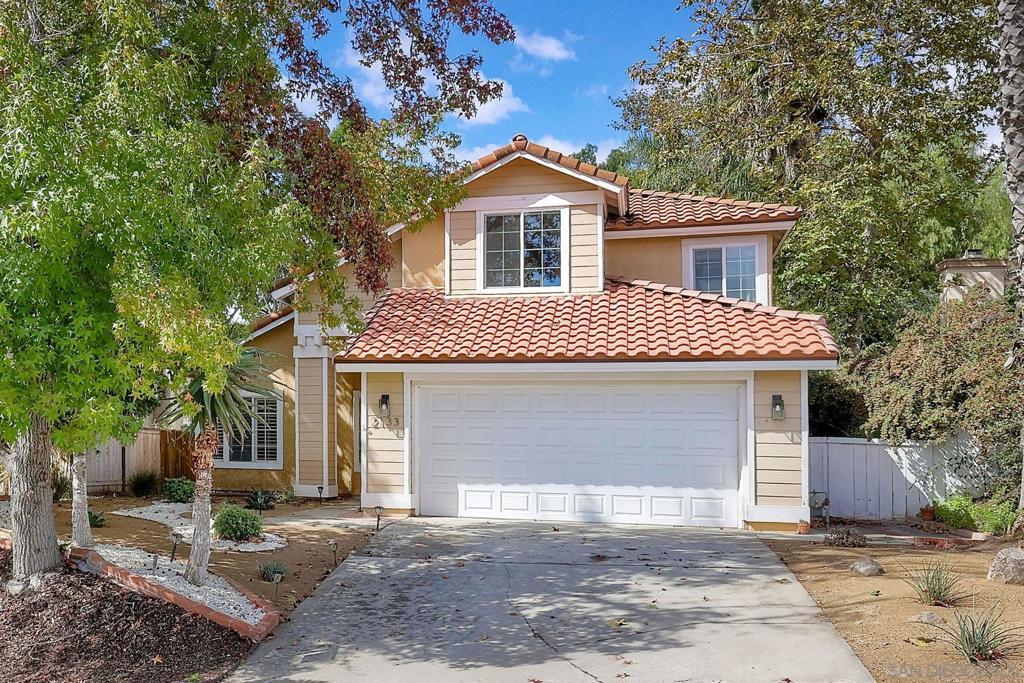 Near Lake Hodges this 4 bed/3 bath Summercreek home offers 2,324 square feet of well designed living space. As you enter, you’ll be impressed by the open, airy living/dining room with vaulted ceilings, plantation shutters, and dramatic staircase with a skylight above that provides an abundance of natural light. The kitchen boasts high ceilings with windows above the cabinets that brighten the space. A deep single basin sink overlooks the peaceful backyard, while the adjacent breakfast nook, framed by bay windows, offers a lovely spot to enjoy your morning coffee. The spacious family room, complete with a cozy fireplace, is perfect for gatherings. A sliding door to the backyard ensures this space is filled with light, making it an ideal spot for family gatherings or quiet evenings at home. Conveniently located on the main floor is 1 bedroom and a full bath, providing versatile options for a guest room, office, or multi-generational living space. Upstairs, the primary suite features vaulted ceilings and multiple windows. The ensuite bathroom includes a double sink vanity, soaking tub, and separate shower. Two additional bedrooms with ceiling fans and a full bathroom with a tub/shower combo complete the upper level. Additional highlights of this home include a 2-car garage, newer AC and furnace, a newer roof, updated windows, and an upgraded electrical panel. With its flexible floor plan, ample natural light, and prime location near Lake Hodges trails and shopping, this home is a true gem. Don’t miss your chance to make it yours!