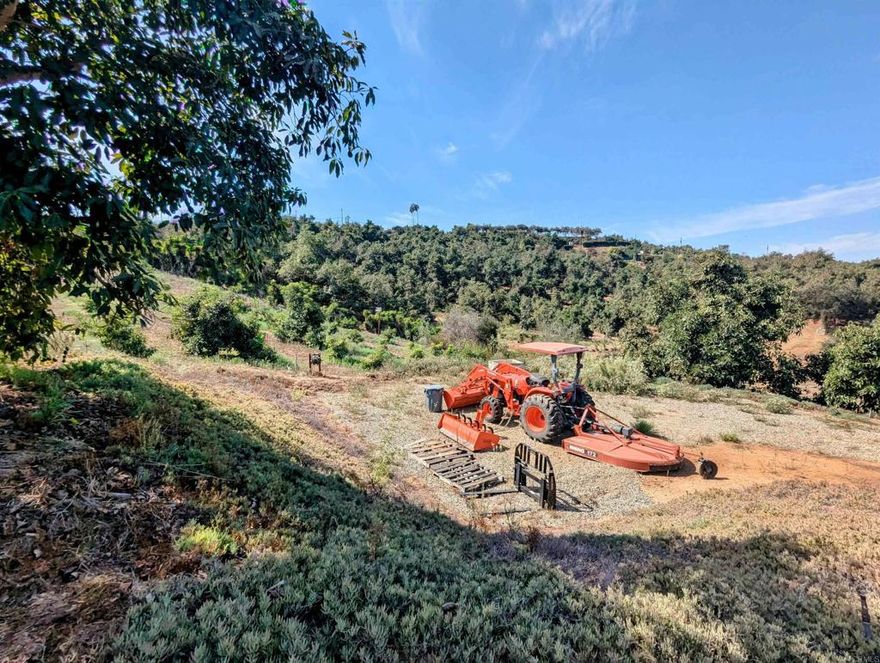 This expansive 18+ acre property offers a prime building site with breathtaking panoramic mountain views. It features a professionally managed avocado grove with a mix of mature, producing Haas and Fuerte trees, along with recently planted ones, ensuring both immediate and future yields. The property has a 3-bedroom septic layout on file, a 2-inch water meter already installed, and paved road access with power nearby. There is no HOA, allowing for more flexibility, and manufactured homes are permitted in the area. The seller is also willing to offer financing. Conveniently located near Highway 76 and in close proximity to I-15, this property provides easy access to surrounding areas while still offering a private and serene setting. It is an excellent opportunity for those looking to build a custom home, invest in agriculture, or enjoy rural living with modern conveniences nearby