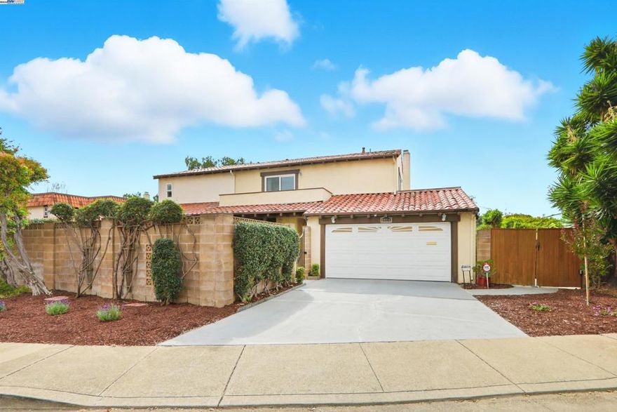 Introducing this timeless Spanish-style two-story home tucked away in the desirable Las Casitas neighborhood! This rare four-bedroom floor plan sits on a quiet cul-de-sac and is loaded with upgrades inside and out. The beautiful kitchen showcases granite counters, a tile backsplash, recessed lighting, ample counter space and a stainless steel refrigerator. Additional highlights include energy-efficient dual pane windows, laminate flooring downstairs, newly installed carpet upstairs, fresh interior paint, and a cozy fireplace. The spacious primary suite offers a large closet and a private balcony with views of the hills. Step outside to a generous backyard with a covered deck, lush lawn, storage shed, and mature fruit trees including orange, lemon, and pomegranate — perfect for entertaining or relaxing outdoors. Ideally located just a short walk to Plaza Park and minutes from 880, 680, the Dumbarton Bridge, Centerville Amtrak Station, and BART. Close to great schools, parks, local eateries, shopping, and entertainment — this home truly has it all!