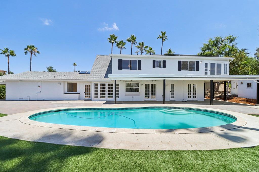 Experience extraordinary living in this beautifully reimagined Farm Style Contemporary residence, tucked away in the scenic hills of Fallbrook. If privacy, versatility, and wide-open space top your list, this nearly 4-acre property delivers—whether you’re dreaming of a hobby farm, space for large animals, room for storage, or simply a peaceful escape from the everyday. A gated entrance and fenced-in property welcomes you with mature palm trees, citrus groves, and a long driveway with ample parking. The main home (2,096sf) features 3 bedrooms, 2 bathrooms, and a spacious loft, all bathed in natural light and enhanced by soaring ceilings and brand-new luxury vinyl plank flooring. Along the back wall of the home, French doors in the kitchen, dining room, guest bedroom, and bathroom open to views of the pool—creating seamless indoor-outdoor flow. The kitchen is equipped with a new Thor 36” range and a 46-bottle wine cooler. Blending rustic charm with modern comfort, the open layout offers timeless character and an inviting atmosphere. Out back, a sparkling pool sits perfectly between the main house and a stunning detached ADU (permitted with a separate address). The 2-bedroom, 2-bath, 950sf guest home is ideal for multi-generational living, visitors, or rental income, and has been extensively renovated for stylish, turnkey comfort. Behind the ADU, you'll find an additional storage shed and a fenced area for animals. The finished two-car garage has also been upgraded with overhead lighting, full drywall, paint, and custom wainscot detailing—creating a versatile space for gatherings, projects, or a workshop. Another detached storage shed has been converted into a cozy bonus space, complete with finished flooring, A/C, a mounted TV, and a sleeping area—ideal as a retreat, studio, or guest hideaway. With panoramic views and the tranquility of nature, this property offers an unmatched sense of peace and possibility. The home also features Fully Paid Solar, helping to warm the pool and offset the electric bill. The nearly 4-acre lot includes a variety of fruit trees such as grapefruit, lime, lemon, peach, orange, avocado, and pomegranate. A gravel road leads to a private gate that opens to a wide expanse of open land, perfect for walking, hiking, and exploring. Located at the end of a private street in Gird Valley near Monserate Winery, this home is a rare gem. Enjoy proximity to 8 golf courses and 10 different wineries, all within 25 minutes. Whether you’re envisioning your dream country estate, a family compound, or an income-generating investment, this home delivers style, space, and soul.