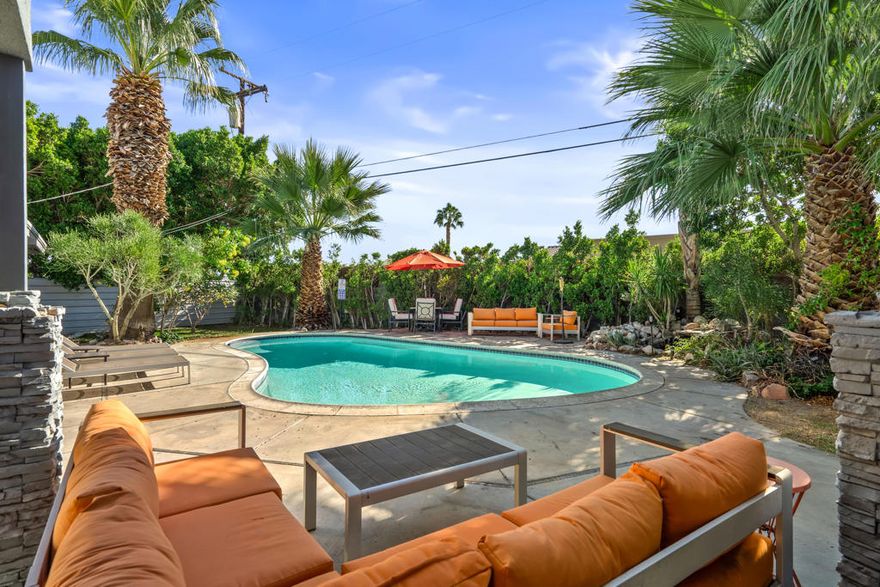 Welcome to your serene 1958 retreat!  Nestled on a spacious corner lot, the San Jacinto Mountains as a backdrop that perfectly blend indoor and outdoor desert living with modern comfort and classic charm. The main house features two ensuite bedrooms, ensuring comfort and privacy and a powder room, while an additional ensuite bedroom in the attached casita provides ample space for guests or family. The great room invites you in with a well-appointed kitchen, a cozy dining area, and a spacious living room, all seamlessly connected. Step through the French doors to a generous outdoor paradise featuring both covered and uncovered patios, a refreshing pool, a sprawling lawn, and relaxing water feature, surrounded by lush desert vegetation, all enclosed by a privacy wall. This meticulously updated home boasts modern baths, new windows and doors, multi-zone A/C, a newer water heater, and a recently replaced roof. Located just minutes from downtown Palm Springs, this oasis offers convenience and tranquility in one perfect package. Come and experience the magic of desert living today!