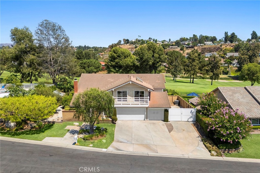 Many people desire to live on a golf course. How about having your home border the 5th hole of Yorba Linda Country Club? This home is just that home. On a big lot with a wonderful pool and spa, how could it be better. Great views including from the primary bedroom. As you drive through the neighborhood, you will see several remarkable homes. And, it is a wonderful neighborhood to live in. It has a comfortable feel and large rooms inside. A spacious living room with a fireplace and then a dining room. Open space is a desirable quality, and the kitchen is open to the family room with views to the backyard as well. The kitchen has newer appliances, double ovens, and a microwave over the cooktop. Corian counters provide great space to prepare meals or to sit for breakfast. The first floor also has a large downstairs bedroom with a ¾ bath across the hall for your guests or family member. Let’s go upstairs. There are three bedrooms upstairs. Two of the bedrooms have a Jack and Jill bathroom to accommodate them. If you like large bedrooms, of those two is quite large. Primary bedrooms should invite you into a luxurious space and this one does. It is a primary suite and very spacious with great views. The master bath matches the size of the bedroom with two separate sinks, a vanity area, a jetted tub, and large shower that has two shower heads and equipped for a steam shower. A bidet and toilet complete the space. Now, step into the expansive walk-in closet with mirror door entrance. In the front portion of the house on the second floor is the bonus room with a balcony that stretches the full length of the room. With a big lot you get space from your neighbors, here you also get fruit trees and landscaping and a walkway that leads you onto the golf course. You get a pool with a slide, and a spa, a covered patio that serves as a place to relax and enjoy the views of the course and the pool. Large 3-car garage, a large and long RV parking area that will fit a big RV. Solar panels on the roof as well, and you are ready to go. Well worth a look as your next home!
