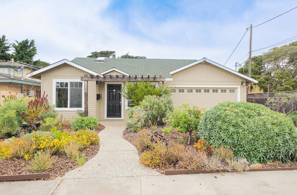 Welcome to this beautifully rebuilt home in 2005 nestled in a desirable sun-belt area of Monterey! This 1591 sq ft layout has vaulted ceilings and an open floor plan that seamlessly connects the spacious living room, dining area & well-equipped kitchen. The living space has a wood burning fireplace & is versatile, with room for multiple sitting arrangements & the double-pane windows & skylights allow natural light to fill the space. The cooking-inspired kitchen boasts upgraded lighting & cabinets with drawers, dividers, 2 pantry cabinets & more. The hallway has a wall of windows & sliding glass door that transitions into the primary suite and offers access to the patio. The over-sized primary retreat includes a gas-log fireplace, TV niche, walk in closet & beautiful en-suite bathroom. The home offers 2 additional bedrooms, full guest bathroom and indoor laundry closet. Plenty of storage for bikes, beach gear or tools in the 2 car attached garage. Both front and back yards are landscaped with beautiful plants and trees (enjoy Fuji apples, apricots, lemons & more) creating a private & serene garden. The backyard also offers an area for gardening, outdoor dining & entertaining. Be sure to see this beautifully maintained home that caters to modern lifestyles & relaxed coastal charm.