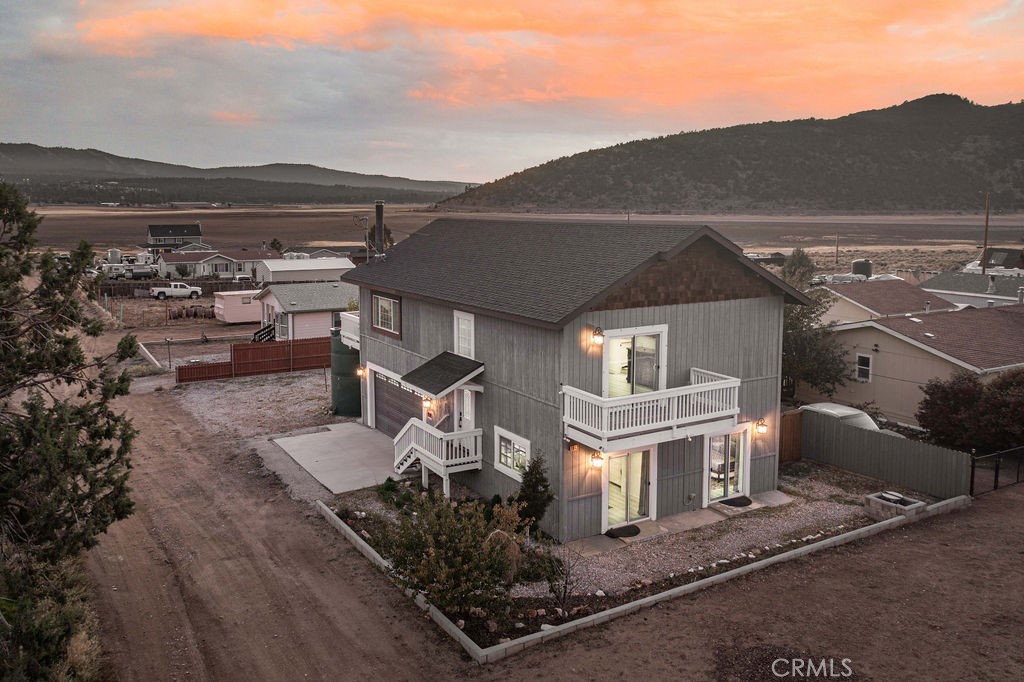 Panoramic mountain and ski slope views! Built in 2008 and recently remodeled, this beautifully updated home blends modern design, comfort, and year-round mountain beauty. It captures stunning views of Snow Summit, Bear Mountain, and the surrounding ranges from nearly every window. Step inside to a light-filled open floor plan where large dual-pane windows fill the living area with natural light. The space flows seamlessly into the dining area and upgraded kitchen, featuring tons of cabinet storage space, granite countertops, stainless steel appliances, and a spacious center island perfect for gathering. Enjoy cozy evenings by the freestanding wood-burning stove or start your mornings on the upper deck with coffee as the sun rises over the mountains. The oversized upstairs primary suite offers a private retreat an en suite bathroom with a deep soaking tub, and a walk-in closet. Sliding doors open to a private balcony overlooking the valley, the perfect spot to unwind and take in the scenery. On the lower level, two additional bedrooms provide generous space for family and guests, along with a full bath, laundry room, and garage access. An extra-deep two-car garage, currently designed as a game room with foosball and air hockey tables; offering a great space for fun or flexible use as a gym, studio, or workshop. Outside is a large fenced yard with mature fruit trees. The home also features a tankless water heater, and plenty of parking for guests or recreational vehicles. Located just minutes from Big Bear Lake, ski resorts, and miles of hiking trails, this remodeled mountain home offers the perfect blend of peaceful seclusion and convenience. Whether you’re seeking a full-time residence, weekend escape, or investment, this is a great home!