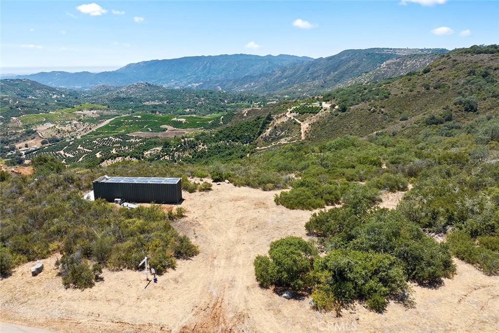 46.45 Acres with Panoramic Views in De Luz
Located at the end of a quiet cul-de-sac in the scenic De Luz area, this stunning 46.45-acre parcel offers rare privacy, breathtaking views, and endless potential. Surrounded by citrus groves, the property sits at the northwest end of Via Escalon and enjoys sweeping panoramic vistas—including views of the Pacific Ocean on clear days. The land features a mix of gentle slopes and steeper hills, ideal for a custom estate, retreat, or expanding your own grove. The northern property line borders the Santa Rosa Plateau Ecological Reserve, adding natural beauty and long-term privacy. This property falls within the criteria area established by the Western Riverside County Multiple Species Habitat Conservation Plan (MSHCP); however, the seller has invested significant time and effort to complete the ERP (Equivalent Residential Project) Application for Single-Family Homes. As a result, the property has already been approved for development on 13.16 acres of its least sensitive land—clearing the way to proceed with obtaining a grading permit for the construction of a single-family residence. Water is available at the street, and a fire hydrant is already in place. Buyer to investigate water benefit zone fees and water meter installation costs. Excellent sun exposure makes it ideal for solar energy and pool heating. Just minutes from Temecula and Fallbrook, this is a rare opportunity for peaceful rural living with modern convenience.