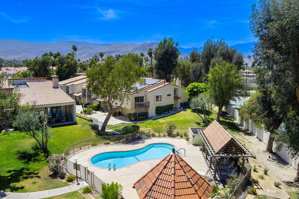 Beautiful End-Unit in South Palm Desert with Mountain and Pool Views. Community is a Planned Unit Development. Solar Lease with great terms!Welcome to this charming home nestled in the heart of South Palm Desert, just steps from the pool and moments away from the vibrant El Paseo shopping and dining district.This spacious home features an open floor plan with 2 bedrooms, 2 bathrooms, a comfortable living room, and a versatile family room/den complete with a cozy gas fireplace and a serene atrium.The kitchen boasts white cabinetry, stainless steel appliances, and ample storage, making it perfect for both everyday living and entertaining.Enjoy vaulted ceilings that enhance the airy feel throughout the home, and step outside to a private patio with BBQ, ideal for relaxing or hosting friends.The primary bedroom includes a balcony with beautiful views, perfect for morning coffee or evening unwinding.The well-maintained community features 3 sparkling pools, spas, and tennis courts, all just a short walk from your door.Don't miss this opportunity to enjoy desert living at its best in a prime location!