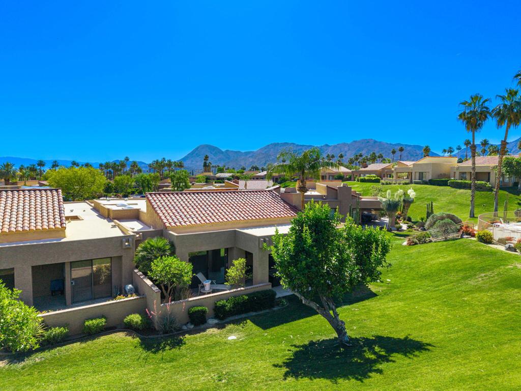 Wonderful, quiet setting at the end of the cul de sac. Very private back yard with views of the mountains, large area of lawns and only a few short steps to the pool and spa. The gated entry leads to a large front patio so you can enjoy the outdoors at both the front and rear of the home. The den has been significantly expanded and offers a 3rd sleeping area. Very open plan. Tall ceilings and lots of windows make the home light and bright.