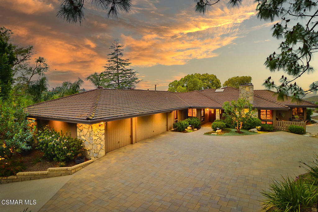 Welcome to 383 Thorpe Circle, an extraordinary and lovingly maintained single-story home in Thousand Oaks, offered for the very first time by its original owners. This custom-built gem, spanning approximately 4,000 square feet, gracefully combines comfort, craftsmanship, and serene natural beauty in one spectacular property.Step through double doors into a bright, skylight entry, where a charming indoor garden atrium brings natural beauty to the nature inspired living spaces. The expansive great room, accented by soaring wood-beamed ceilings, brick fireplace, and large windows, fills the space with natural light while offering panoramic views of lush landscaping and scenic hillsides. Designed for both entertaining and everyday living, the well-appointed kitchen and dining areas showcase ample cabinetry, tasteful finishes, and a charming breakfast nook. A dedicated laundry room conveniently sits adjacent, boasting abundant storage and functional workspace. With four spacious bedrooms and three and a half thoughtfully designed bathrooms, the home offers flexibility and comfort for family and guests alike. The luxurious primary suite is a true sanctuary. This private retreat, featuring vaulted ceilings, walk-in closet, a separate sitting area, expansive dual-sink vanity, and a spa-like bath complete with a soaking tub and beautifully tiled shower. A possible fifth bedroom currently serves as a sophisticated home office, featuring rich built-ins, a cozy fireplace, and direct garden access, perfect for quiet reflection or productive workdays. Outside, the backyard is an enchanting haven featuring multiple outdoor living areas, ideal for gatherings or peaceful relaxation. Highlights include a spacious deck, rustic stone fireplace, inviting spa, winding pathways, vibrant gardens, and a tranquil meditation labyrinth, all harmoniously blended within a backdrop of mature trees and expansive views. This residence, with meticulous attention to detail, abundant storage, and exceptional craftsmanship, is not only a home but a cherished piece of Thousand Oaks real estate awaiting its next chapter. Embrace the opportunity to call 383 Thorpe Circle your own and experience a lifestyle defined by beauty, tranquility, and refined living.