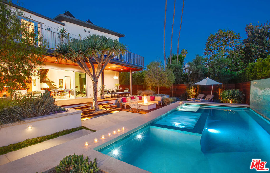 Call listing agent for information regarding while property is withdrawn. Once-in-a-lifetime opportunity to own an exceptional and very private resort estate situated on one of the historic Venice walk streets. The rare double-lot property features a California-modern main residence with 4BR+3.5BA including a media room or 4th bedroom and office with separate entrance. There is a detached 2-story structure that includes a ground floor pool house/family room with half bath & exterior shower. The upper level guest suite with open living and bedroom area, full bath and lounge-balcony overlooks the expansive grounds and pool. The main house living and dining rooms flow out to the resort-like grounds that are designed for ultimate privacy and is the setting for many layers of activity including 2 lounging-sun areas, exterior living room surrounding the fire feature, al fresco dining with built-in heat lamps, exterior BBQ kitchen with sink & refrigerator plus a 2nd dining area near the guest & pool house. The focal point of the yard is a stunning pool & spa with a breathtaking 30-foot-long custom designed blue-tile mosaic mural of a breaking wave. An irresistible lure for the home chef, the gourmet kitchen also serves as a social space and includes custom walnut cabinets by Henrybuilt, breakfast bar, Bosch appliances plus a butler's pantry with 2 wine refrigerators and space for all your countertop appliances. The master suite features French doors to a private balcony, walk-in closet, bath with double sinks and a luxurious steam shower. There is a poolside lounging balcony off the 2nd bedroom while the 3rd bedroom is next to the herb garden balcony and shared bathroom. Step down to the media room or 4th bedroom with full bath and separate office, both with private entrance. A fully gated 2-car garage plus 3 additional spaces provide ample parking. Refined and uniquely private this coastal retreat includes features such as floor-to-ceiling and wall-to-wall glass doors that open to reveal the pool and landscaped grounds, radiant floor heat, solar power and an extraordinary south-western exposure for all-day sun and endless sky views. Close to Abbot Kinney shops, restaurants, Pacific Residence Theater and the BEACH! Sometimes the stars align and you actually can have it all!
