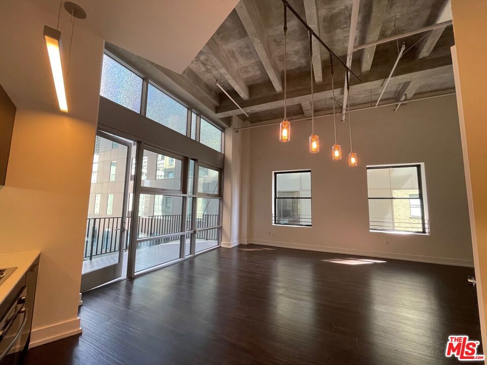 #1115 is a corner loft, features a balcony, soaring ceiling height, lots of natural light with a view facing north and east. "Look and Lease Special." Take up to EIGHT weeks FREE rent on our exclusive move-in promotion. 4 weeks free, 4 weeks on 'Look and Lease" for total of 8 weeks free. Offer subject to change without notice, prices change weekly, book your appointment ASAP and ask for details on this promotion. Welcome to a pet-friendly community offering exceptional comfort and convenience. This bright, spacious loft features soaring ceilings and abundant natural light through large east-facing windows overlooking the serene courtyard. Enjoy premium amenities including: 24/7 fitness center, secure Parcel Pending locker system that notifies you instantly via text of package deliveries to lockers, 24/7 concierge service and valet parking with text retrieval anytime day or night, Bosch brand kitchen appliances: gas range, microwave, dishwasher, and in-unit washer/dryer. Refreshing rooftop pool and hottub, indoor/outdoor lounges with oversized TVs and comfortable seating. Private wine room with lockers and meeting space for gatherings or quiet work. Beautifully furnished guest suite available for residents' visitors, ideal for hosting friends and family. Live in a vibrant neighborhood with Whole Foods, Ralphs, Smart & Final, Target, and Grocery Outlet nearby, plus The Bloc* shopping district is just across the street, featuring Uniqlo, USPS, Alamo Drafthouse Cinema, Drybar, GNC, LaMay Nail Salon, Starbucks, Sheraton Grand Hotel, T-Mobile, Hatch Yakitori, Marugame Udon, Oil + Cream Massage, One Medical, UCLA Health. Building is perfectly positioned above the 7th St/Metro Center station, providing quick access to all subway lines, LA Live, and the LA Convention Center within minutes. Street level of our building is Northern Cafe and Jollibee. Multiple loft options are available in various layouts and price ranges. Prices and lease specials updated weekly. Schedule your tour today to discover luxury, convenience, and peace of mind in one of the most desirable addresses in downtown Los Angeles financial district. Complimentary valet parking while touring.