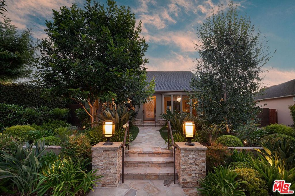 Step into this beautifully updated home, tucked away south of Riverside in charming Toluca Lake. Designed with a spacious single-story layout, this highly upgraded, very custom 3BD/3BA property showcases both timeless architectural charm with refined modern luxury. Enter to find a warm and inviting family room, where engineered hardwood floors, floor-to-ceiling windows, and a striking Onyx stone fireplace set the tone for sophistication. The kitchen is a true masterpiece, featuring quartzite countertops, Sub-Zero and Wolf appliances, an expansive walk-in pantry, and a 1000-bottle, temperature controlled wine cellar. Designed for both culinary creativity and effortless entertaining, the kitchen seamlessly opens to the living room, highlighted by wood-beamed ceilings and dramatic Centor bifold doors opening up to the backyard, creating an indoor-outdoor flow. Down the hallway, two bedrooms await, each with an ensuite bath, including the luxurious primary suite. This retreat boasts dual walk-in closets and spa-inspired bath complete with a dual vanity, a soaking tub, an oversized step-in shower with built-in bench seating, and an automatic Toto toilet. A third bedroom, perfect for guests or a home office, is located just off the living room, along with a beautifully appointed full bath featuring glass handmade Walker Zanger tile. The private, resort-style backyard is designed for both relaxation and entertaining. Enjoy sun-filled afternoons by the heated pool or gather for al fresco dining at the built-in Viking barbecue with side burner. With Sonos surround sound installed indoors and out, every gathering feels elevated. Located moments from the shopping and dining of Toluca Village, major studios, and the scenic Lakeside Golf Club, this updated home is a rare find. Don't miss this exceptional opportunity!