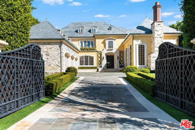 The finest quality, substance & style embody this grand Traditional Manor poised on an over 21,000 sq.ft. lot on one of the most prestigious streets in prime Brentwood Park. Set behind majestic double front gates, this world-class estate w/apx. 15,500 sq.ft. of living space is extremely private & offers an enchanting setting w/meticulously manicured grounds, captivating faade & timeless authenticity. This estate provides an exceptional lifestyle w/the quality & amenities equivalent to a superlative five-star hotel. The main level is complete w/impressive formal foyer, formal living rm, library, formal dining rm, family rm & gourmet kitchen w/breakfast rm. 5 family bdrm suites upstairs & the magnificent master suite w/fp, terrace, onyx bath & custom closets/dressing rms. The lower level features billiard rm w/bar, wine rm, movie theater, gym, laundry rm & staff apartment. The rear grounds are completely private w/towering hedges, patios, lawn, pool, spa & detached pool/guest house.
