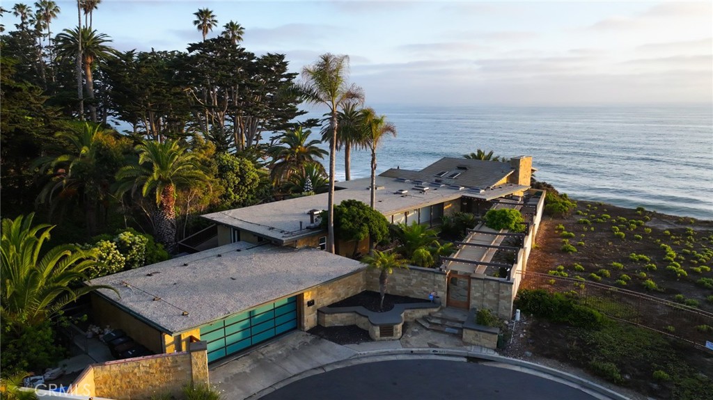 Poised at the end of a private, ocean front cul de sac in the coveted Cyprus Shores community, this residence looks straight out to Cottons Point with unobstructed views all the way up the coastline to Dana Point and out to Catalina & San Clemente Islands. The iconic house holds a slice of history, especially for surf culture, as the previous residence of the late John Severson of Surfer Magazine, and for it’s close proximity of the Nixon Estate, La Casa Pacifica. The rare lot is the largest on the bluff in the neighborhood boasting over 14,700 sq.ft. The mid-century beach house features authentic post and beam ceilings throughout, travertine floors, two outdoor showers, and five bedrooms including a secluded guest quarters. The gourmet chef’s Kitchen is complete with every imaginable appliance from a SubZero refrigerator to a Dynasty oven & gas stove top with griddle, two sinks, a large island, wine fridge, and extensive storage. Step up to the Living Room with a grand fireplace and windows looking over the Pacific Ocean. The Master Retreat is tucked into the side of the cliff and exudes the feeling of being on a boat staring at the waves. The property has over 1,500 sq.ft of wrap around deck with an in ground jacuzzi and room to entertain a plethora of guests. Walk down the private steps to the renown South Gate/Cottons Point beach and just minutes up the beach to the world class surfing at Trestles. Truly a one of kind gem in the beautiful town of San Clemente.