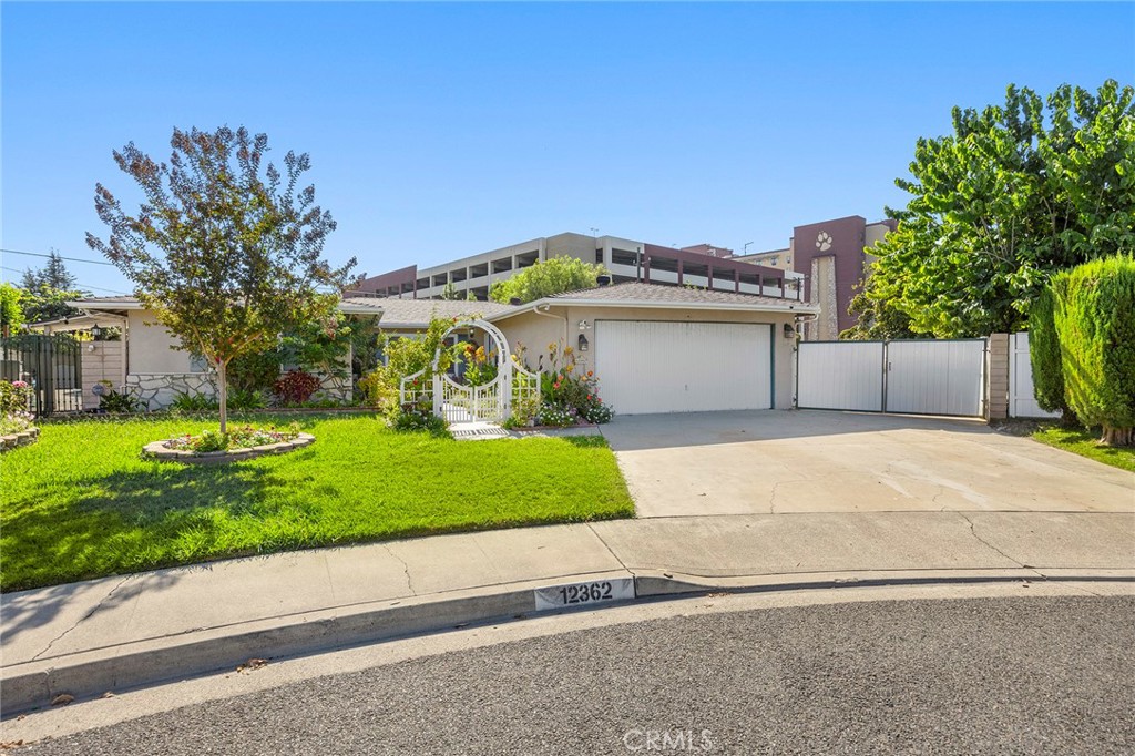 Tucked away at the end of a quiet cul-de-sac, this East Garden Grove gem offers an exceptional blend of comfort, versatility, and location. Just minutes from the world-class dining, shopping, and entertainment of the Anaheim Resort District, this home provides both convenience and retreat-like privacy.
Spanning 2,001 sq. ft., the residence features 4 bedrooms and 2.5 bathrooms on an expansive 9,405 sq. ft. lot. The backyard is a private oasis complete with a sparkling in-ground pool, lush gardens with mature landscaping, a soothing waterfall feature, and two covered patios—perfect for entertaining or relaxing. A massive gated RV parking area with direct garage access adds to the property’s rare functionality.
Inside, the remodeled kitchen shines with semi-custom cabinetry, a bright color palette, and stainless steel appliances. The spacious primary suite opens directly to the pool area and boasts an ensuite bathroom with dual cedar-lined mirrored closets. Secondary bedrooms are thoughtfully situated off a hallway with its own exterior entrance, creating an ideal layout for multi-generational living or flexible modifications. A formal dining room offers the option to convert into a 5th bedroom if desired.
With its prime location, this home also presents great potential for an ADU or use as a short-term rental. Whether you’re looking for your forever home, an investment, or both, this property delivers incredible opportunities in one of Orange County’s most desirable neighborhoods.