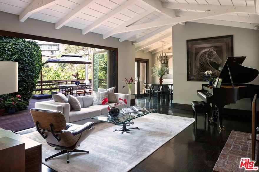 Rarely Available! Enchanting, private, peace-filled oasis hidden in the Hollywood Hills. Beautifully furnished, chic & modern bungalow that's stylish and inviting with all new designer furnishings, 2 fireplaces and (of course) a grand piano. This light-filled home offers wonderful indoor/outdoor living with a stunning south-facing retractable wall of glass in the living room and with each room opening directly onto an expansive 1100 sq ft backyard deck. The lush surroundings are beautifully landscaped with flowers and mature trees. There's an outdoor dining area with a Malm fireplace, gas grill and sunken Jacuzzi. Enter the front of the home through a private gate that leads into a tranquil courtyard and provides added peace and security. Overlooking Hollywood with its iconic palm trees standing tall against the blue sky, the private outdoor view reminds you that you're living somewhere very special. Like a Chateau Marmont bungalow or garden suite at the Beverly Hills Hotel but with the seclusion and tranquility of a single family home.