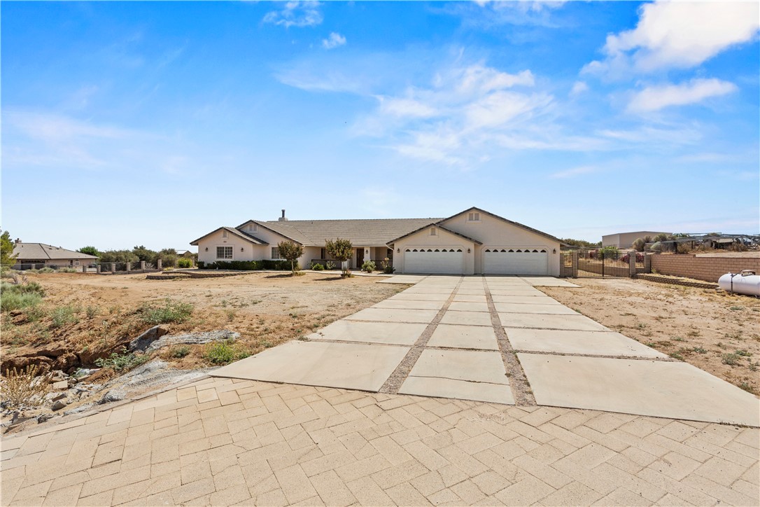 Large rural family home set up with 2 master bedrooms with private bath, one with jacuzzi each located on opposite ends of the house. Assessor listed at 3536 sq. ft. Perfect for mother-in-law quarters with ultimate privacy. Spare room off entry can be used as an office or bedroom. Large indoor laundry room. Home has an abundance of storage. Large kitchen with center island and eating area connects to bonus family room with fireplace. Lots of tile flooring through out.
Kitchen area opens up to large concrete patio across the entire rear of the home. Large 4-car garage that is completely dry-walled. Large 1.72 acre lot completely fenced with RV access on both sides of the home. Home exterior has just been painted. Easy access to neighborhood with all roads paved.